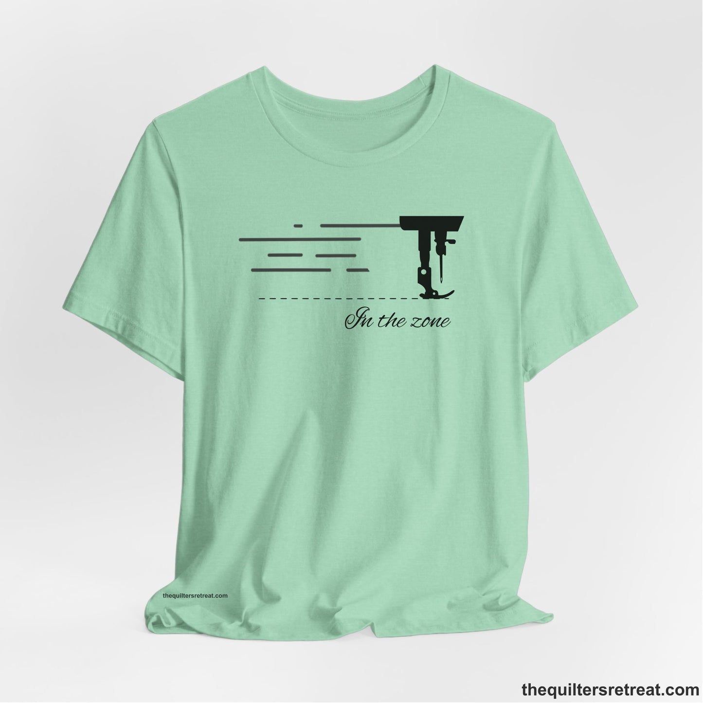A Heather Mint Short Sleeve T-Shirt with a vintage sewing machine illustration with floral accents and "Sewing Mends the Soul" text