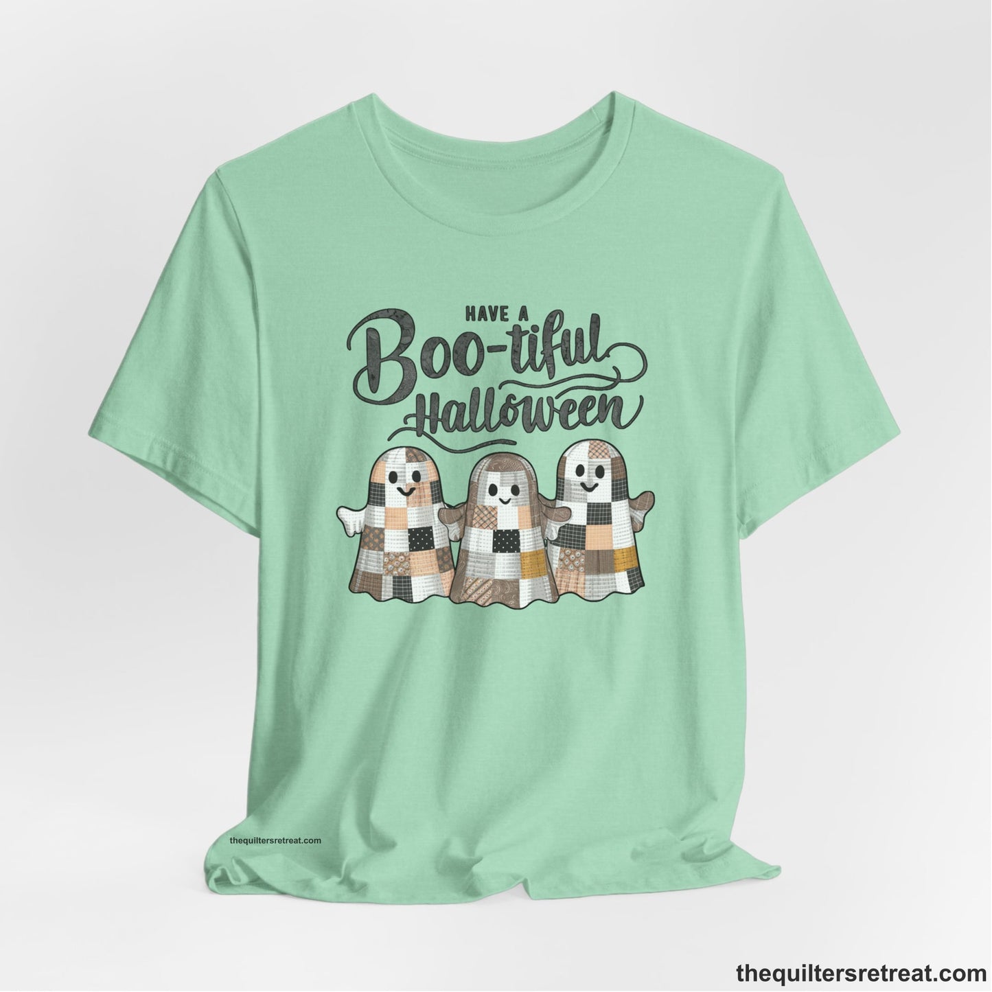 A Heather Mint Short Sleeve T-Shirt with a cute patchwork ghosts with "Boo-tiful Halloween" text in a playful style