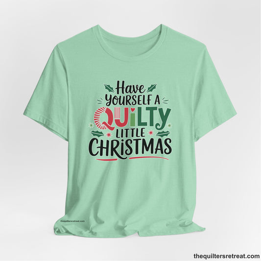 A Heather Mint Short Sleeve T-Shirt with a festive "Have Yourself a Quilty Little Christmas" text with holly and quilt patterns