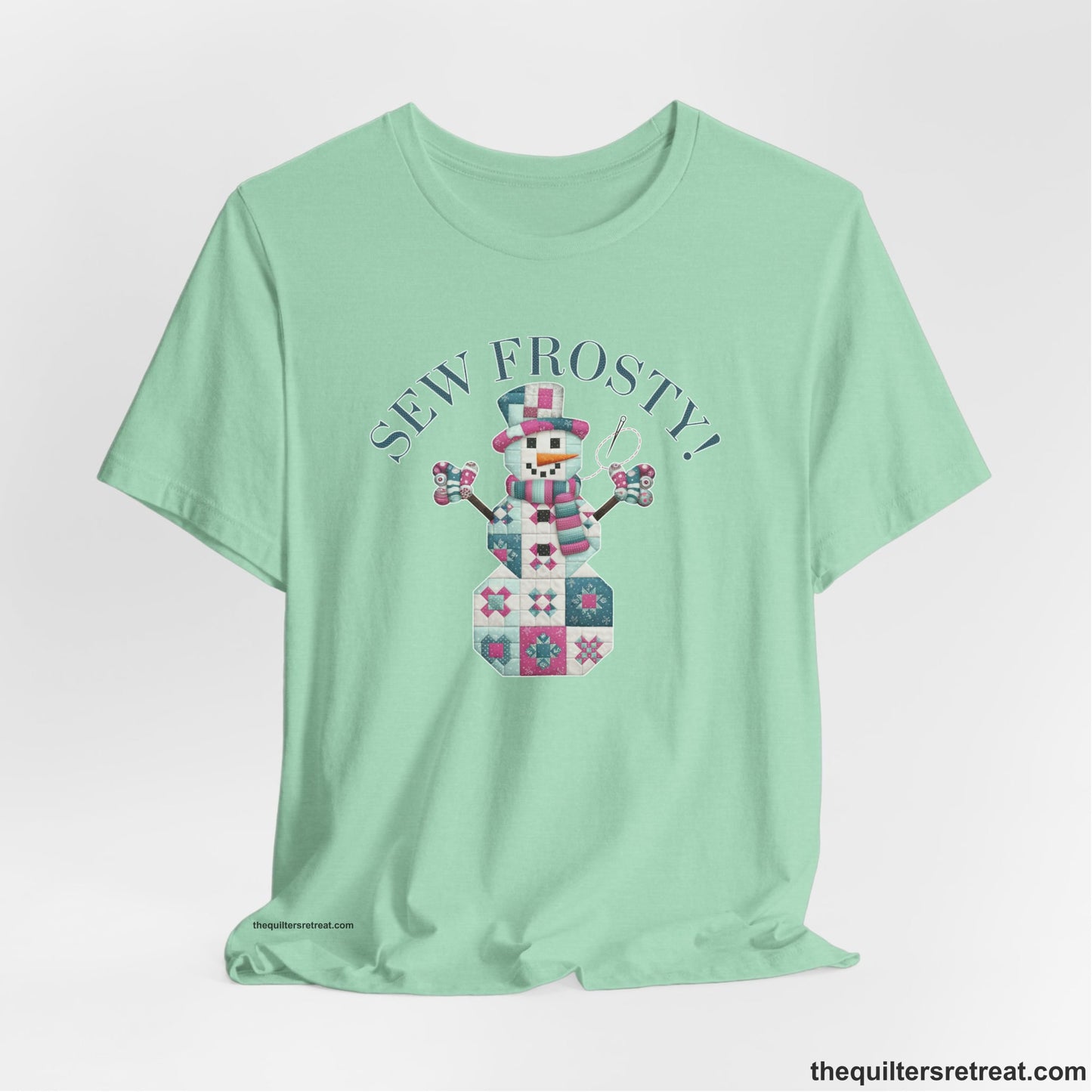 A Heather Mint Short Sleeve T-Shirt with a snowman quilt pattern with "Sew Frosty!" text in a crafty style