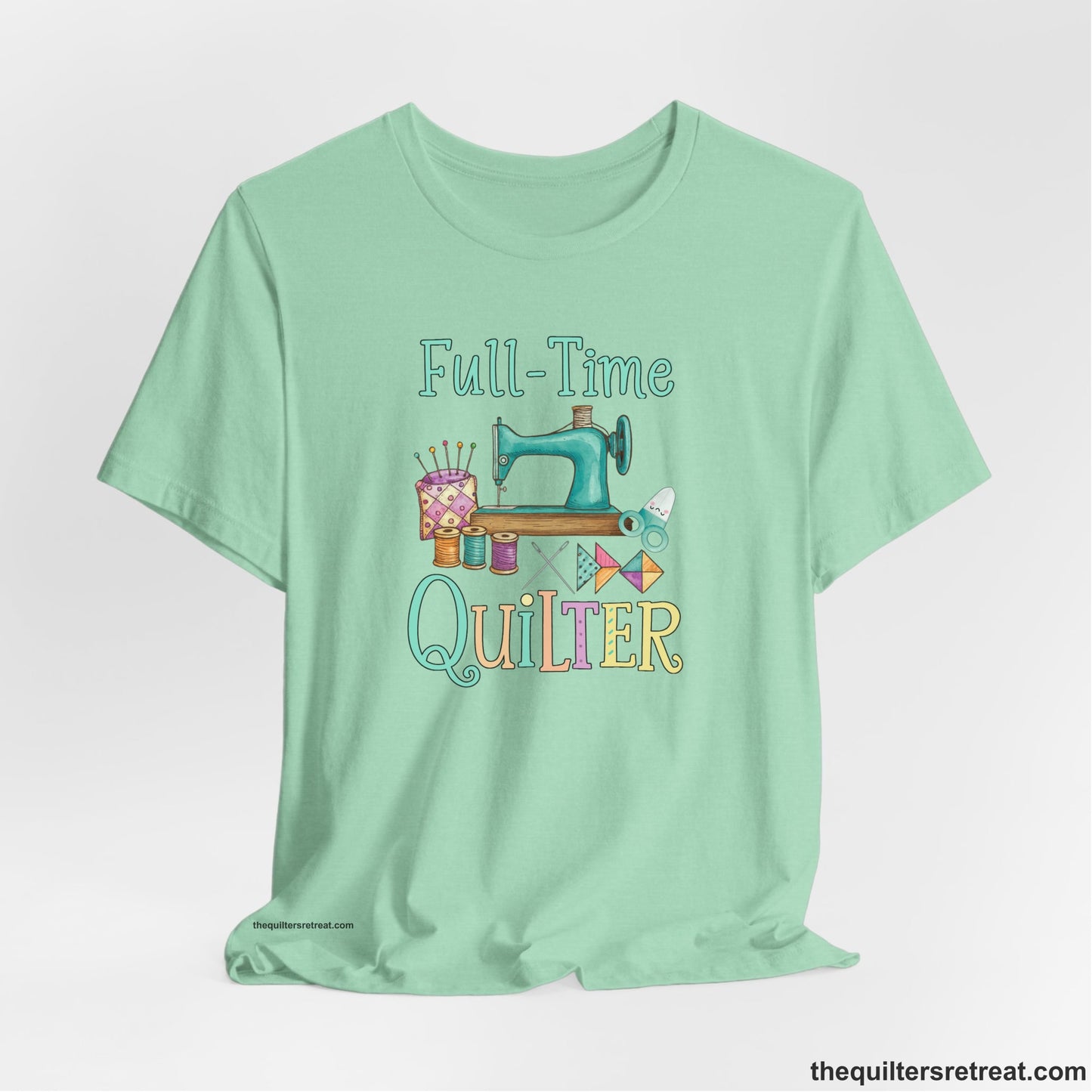 A Heather Mint Short Sleeve T-Shirt with a vintage sewing machine with colorful threads and "Full-Time Quilter" text in playful style
