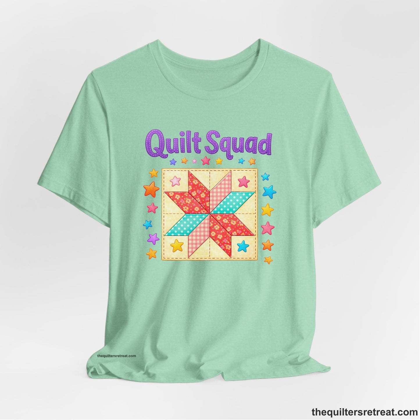 A Heather Mint Short Sleeve T-Shirt with a Patchwork quilt star with colorful stars, playful mood, "Quilt Squad" text.