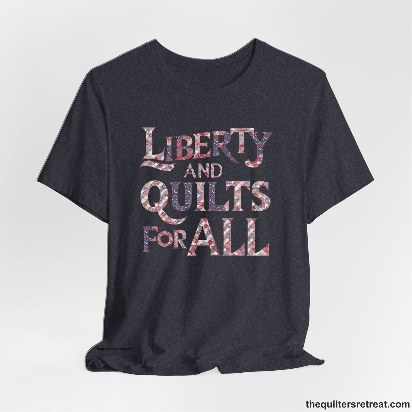 A Heather Navy Short Sleeve T-Shirt with a Liberty and Quilts for All" text with patchwork quilt pattern in a vintage style