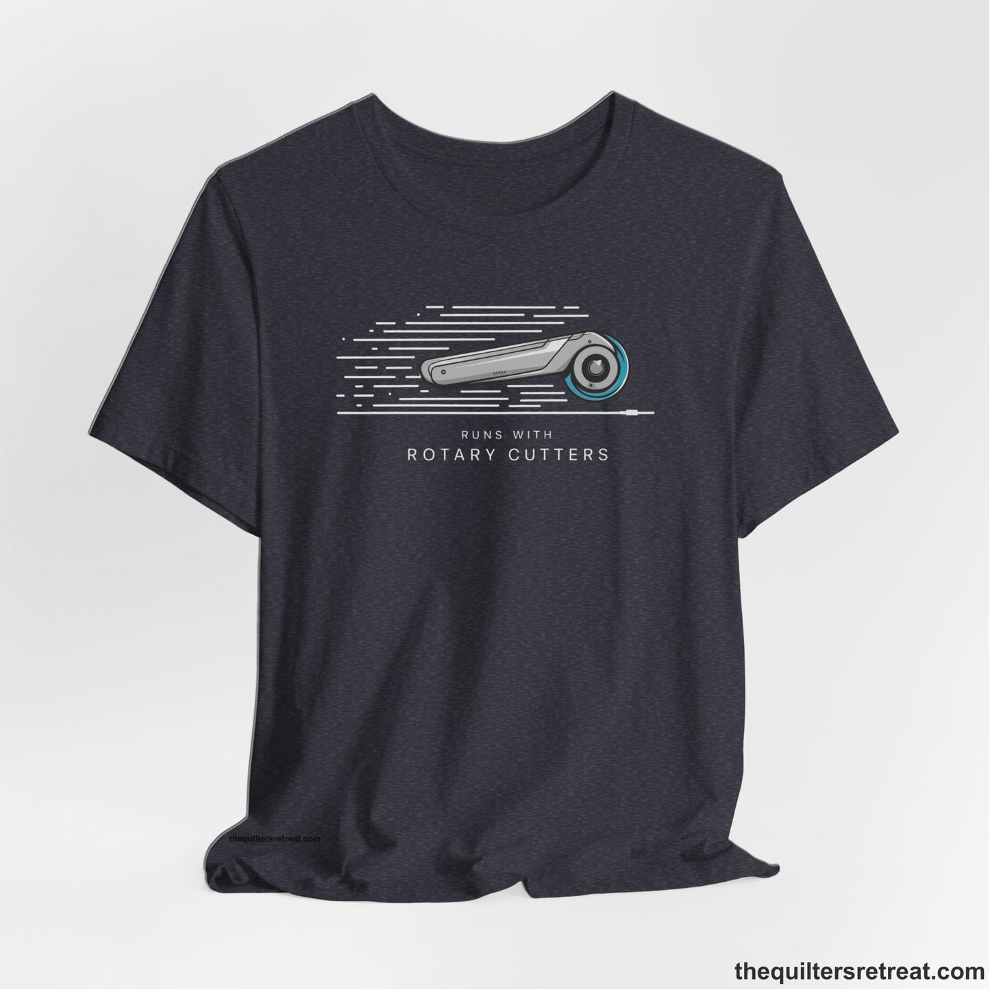 A Heather Navy Short Sleeve T-Shirt with a rotary cutter illustration with dynamic lines and bold "Runs with Rotary Cutters" text