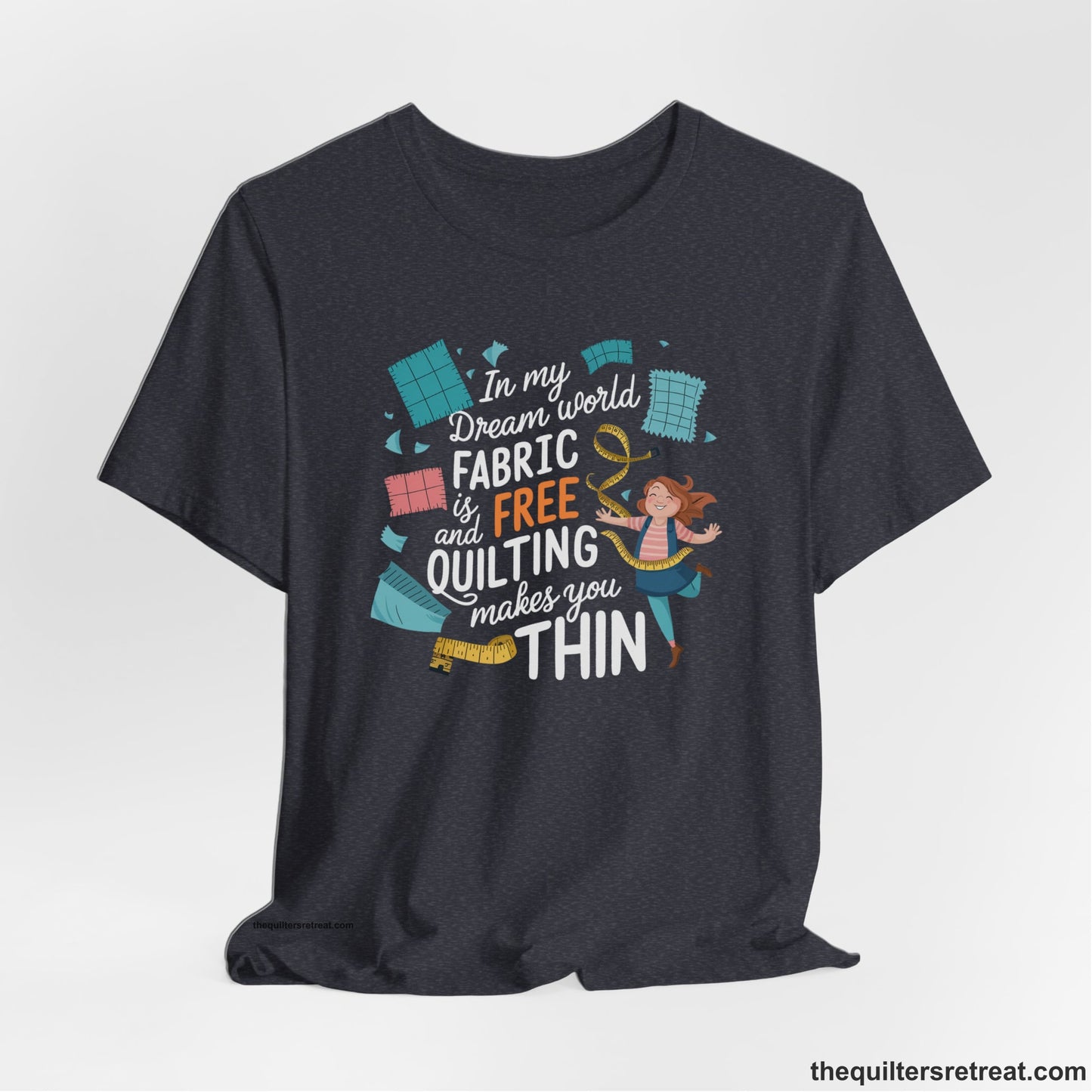 A Heather Navy Short Sleeve T-Shirt with a inspirational quilting text with playful seamstress and colorful fabric scraps in whimsical style