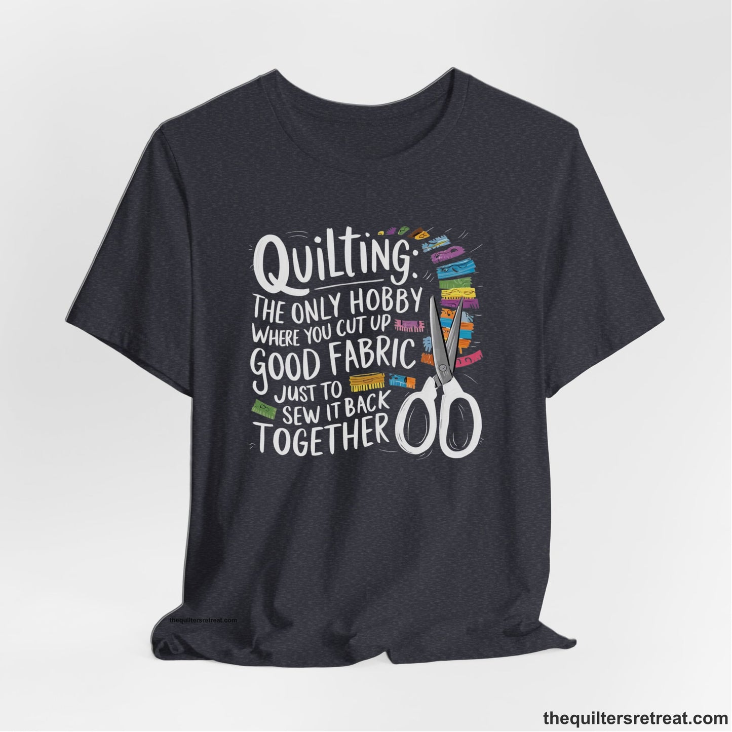 A Heather Navy Short Sleeve T-Shirt with a quilting-themed text with colorful fabric pieces and scissors in a whimsical style