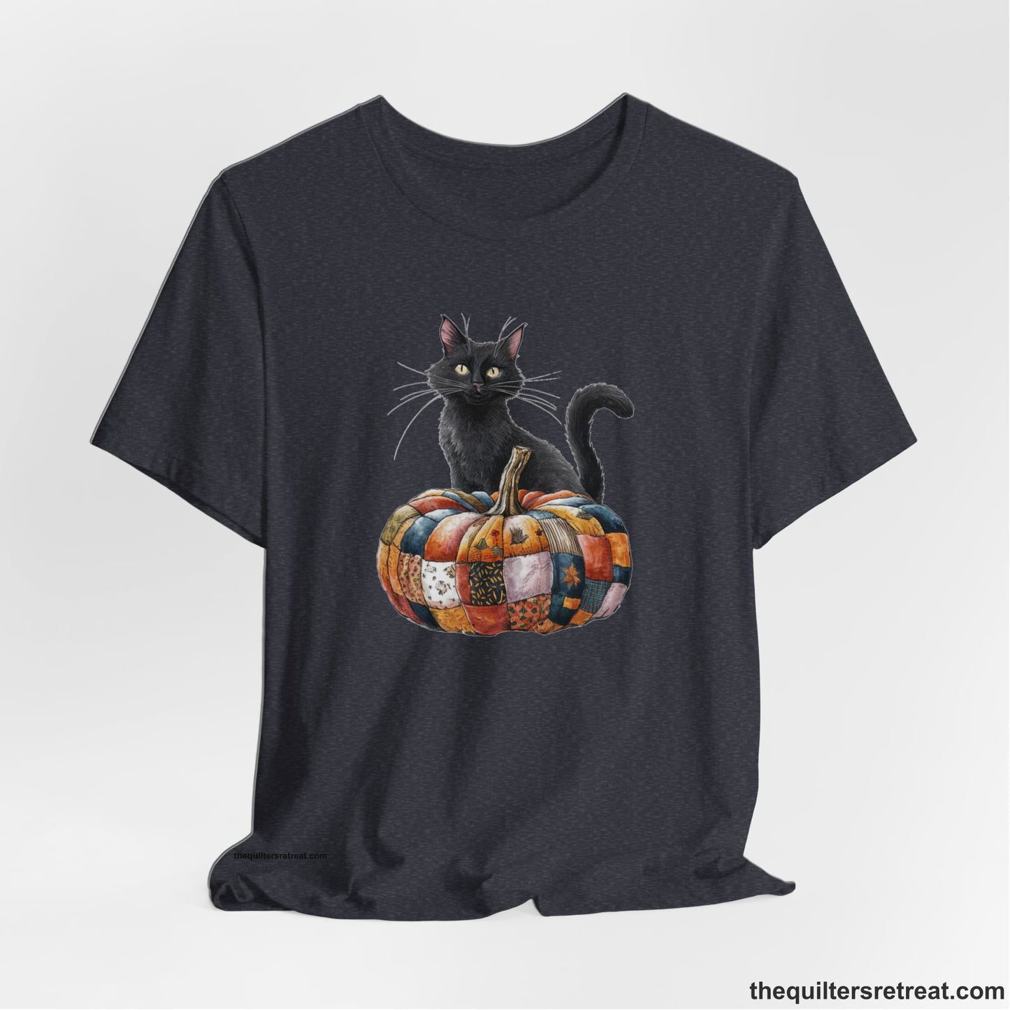 A Heather Navy Short Sleeve T-Shirt with a black cat with a quilted patchwork pumpkin in a whimsical autumn style