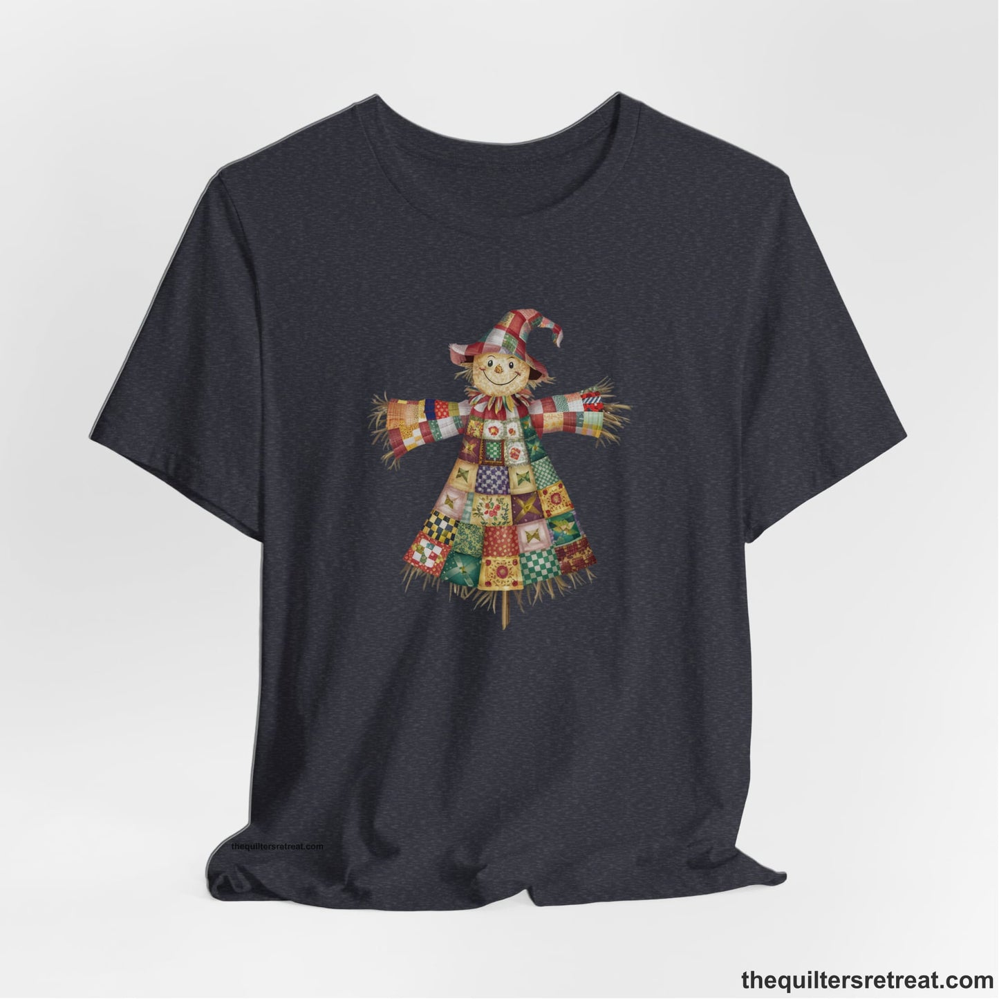 A Heather Navy Short Sleeve T-Shirt with a patchwork scarecrow with a cheerful face in a whimsical style