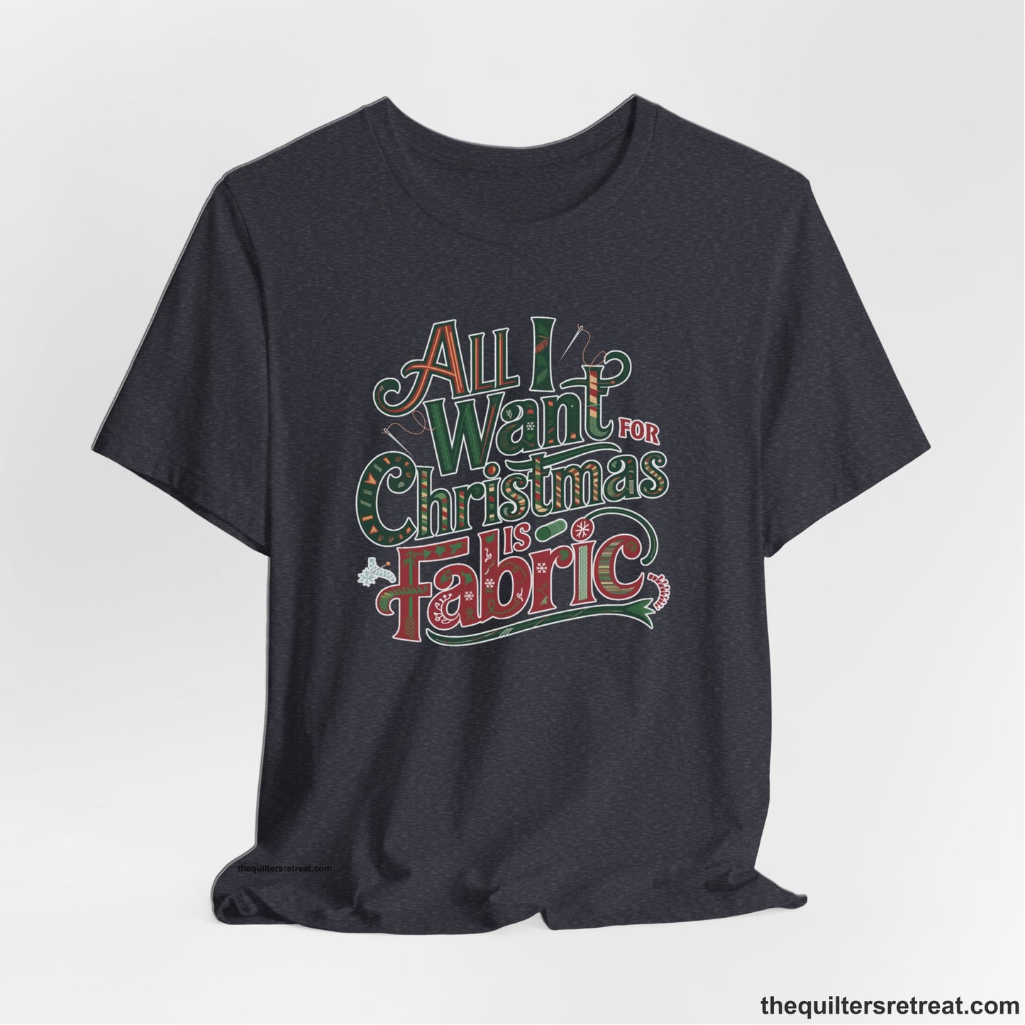 A Heather Navy Short Sleeve T-Shirt with a vintage holiday text "All I Want for Christmas is Fabric" with festive motifs