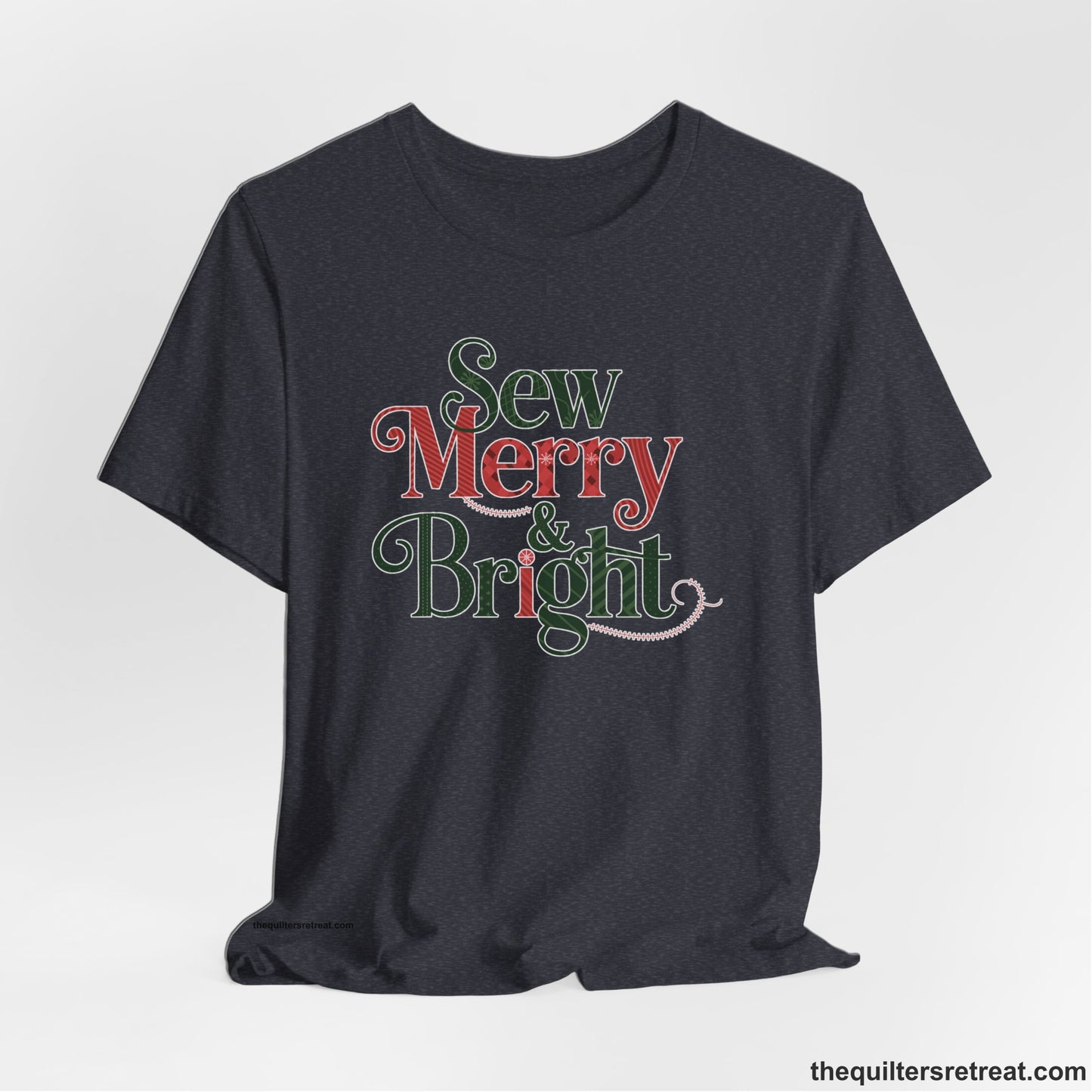 A Heather Navy Short Sleeve T-Shirt with a festive "Sew Merry & Bright" text with decorative holiday patterns