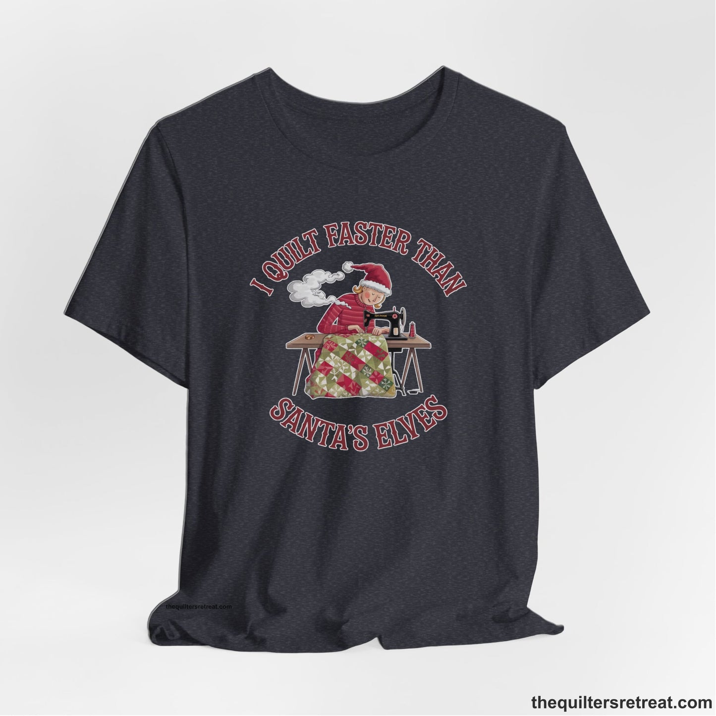 A Heather Navy Short Sleeve T-Shirt with a whimsical illustration of a quilting woman with "I Quilt Faster Than Santa's Elves" text