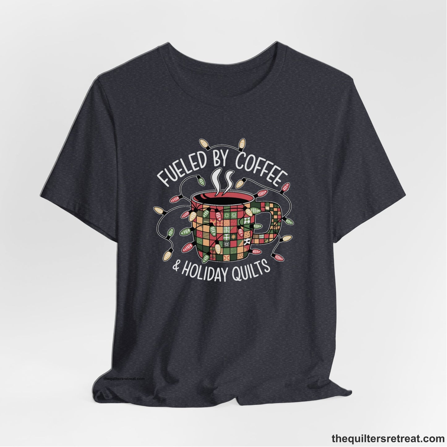 A Heather Navy Short Sleeve T-Shirt with a patchwork coffee mug with colorful lights and subtle "Fueled by Coffee" text in festive style