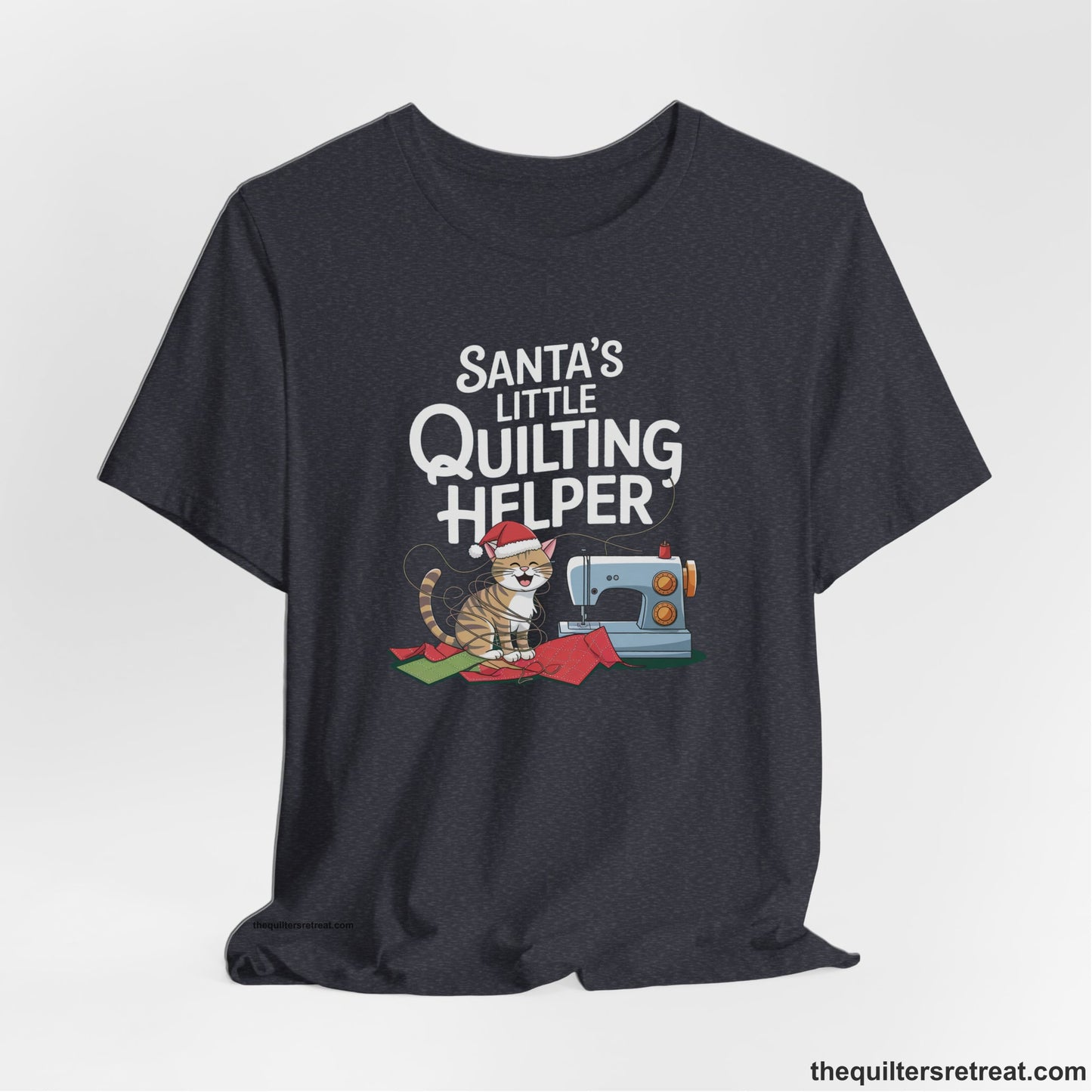 A Heather Navy Short Sleeve T-Shirt with a santa-hat-wearing kitten with a sewing machine and "Santa's Little Quilting Helper" text in playful style
