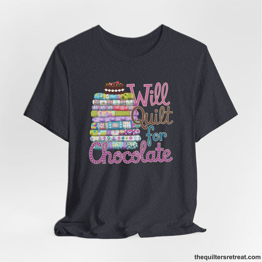A Heather Navy Short Sleeve T-Shirt with a stack of colorful quilts topped with cake, whimsical "Will Quilt for Chocolate" text