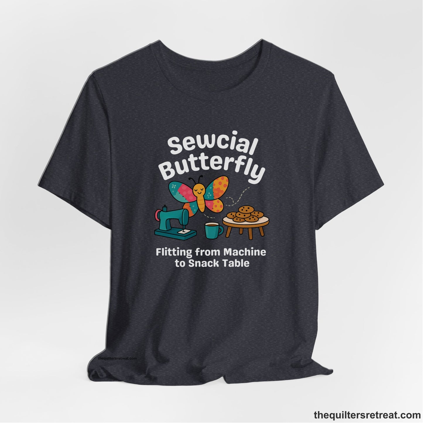 A Heather Navy Short Sleeve T-Shirt with a playful butterfly near sewing machine with cookies and coffee doodle design