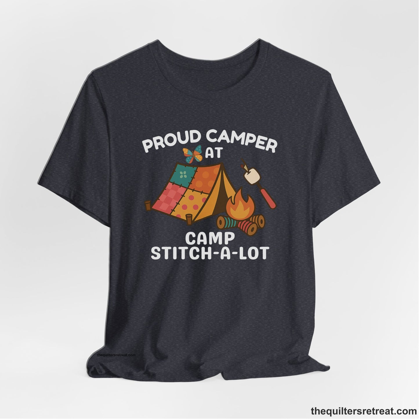 A Heather Navy Short Sleeve T-Shirt with a camping scene with patchwork tent, campfire, and whimsical butterfly and marshmallow illustration