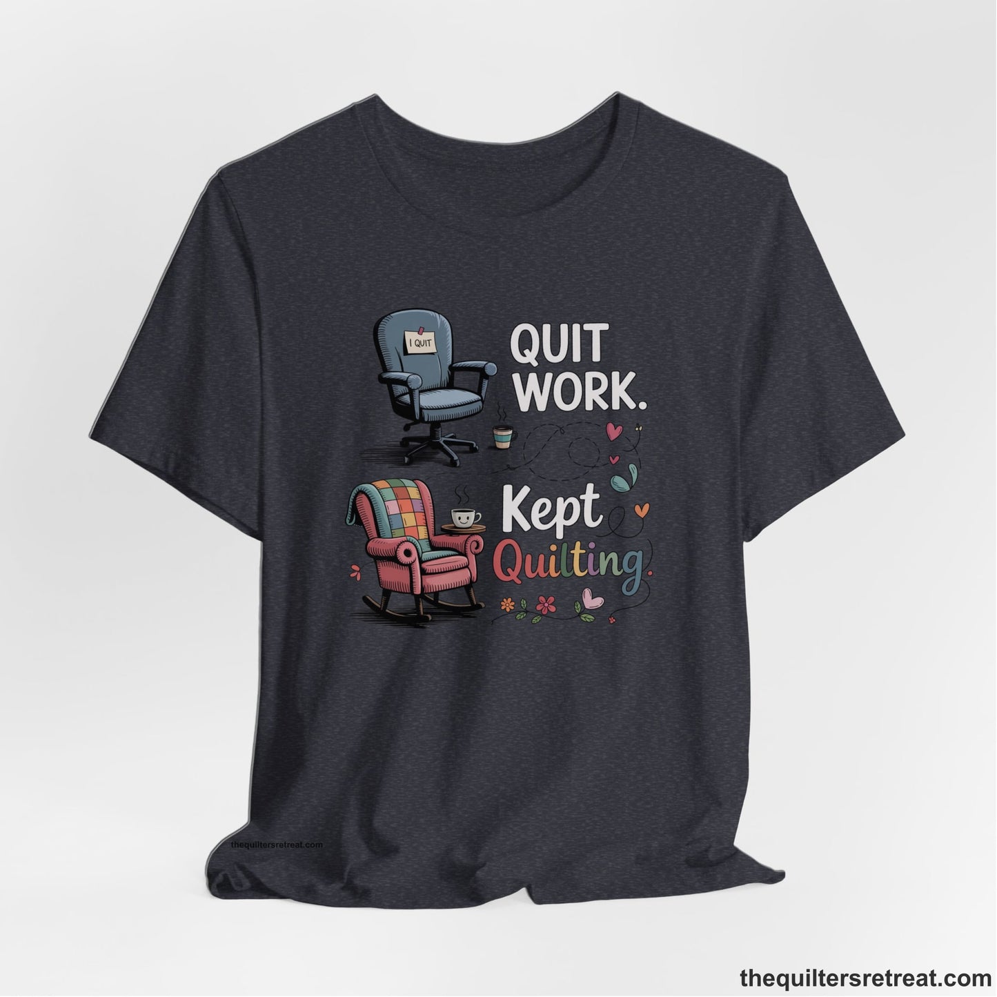 A Heather Navy Short Sleeve T-Shirt with a quit work kept quilting text with cozy chairs and colorful floral accents in a whimsical style