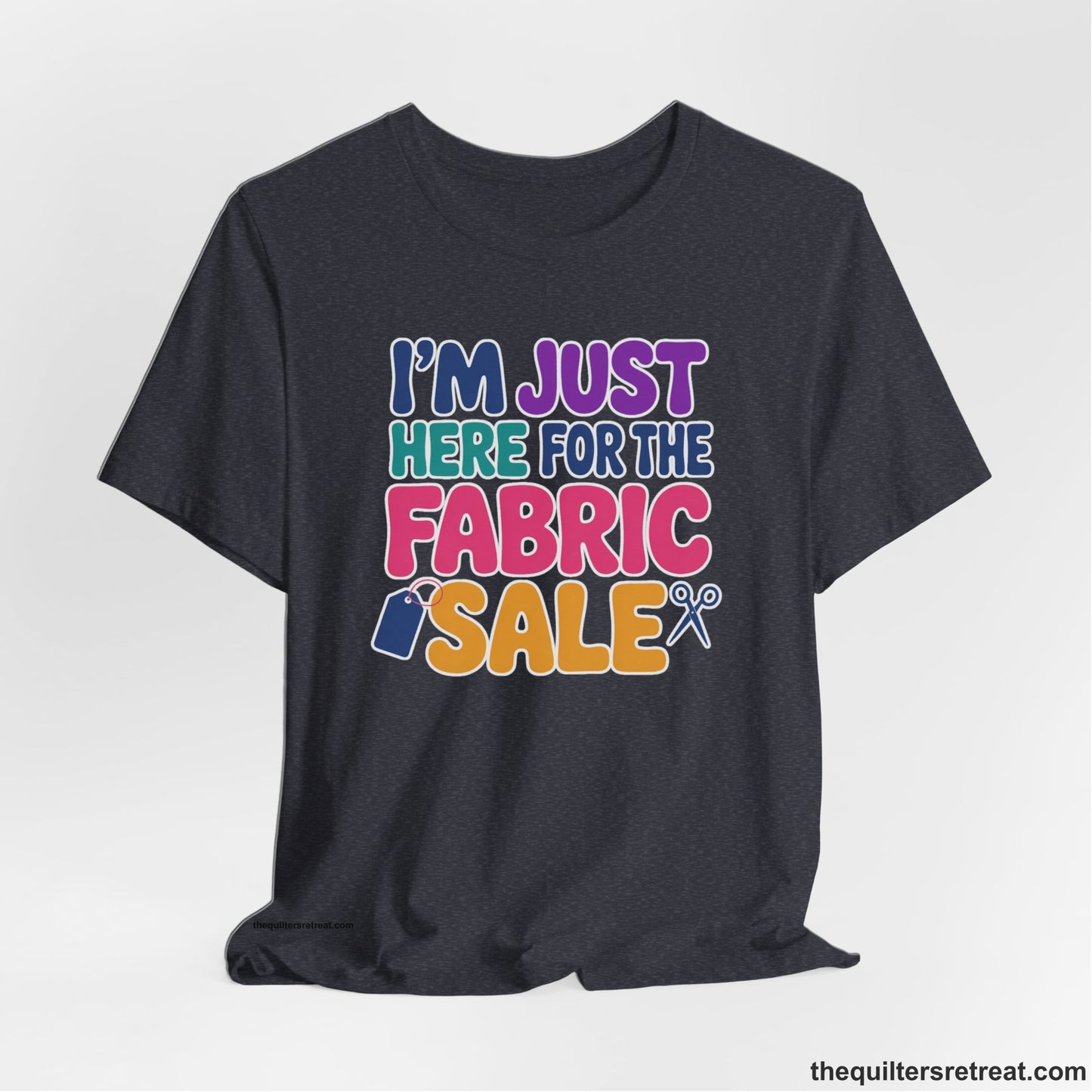 A Heather Navy Short Sleeve T-Shirt with a playful "I'm Just Here for the Fabric Sale" text with colorful letters and sewing icons