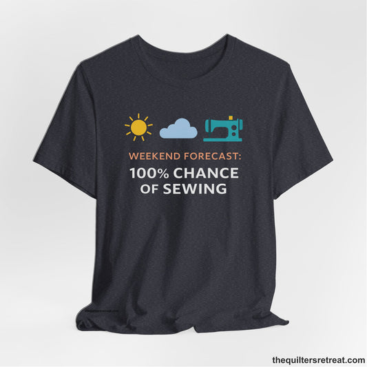 A Heather Navy Short Sleeve T-Shirt with a Sun, cloud, sewing machine icons; bold text "Weekend Forecast: 100% Chance of Sewing"; playful style.
