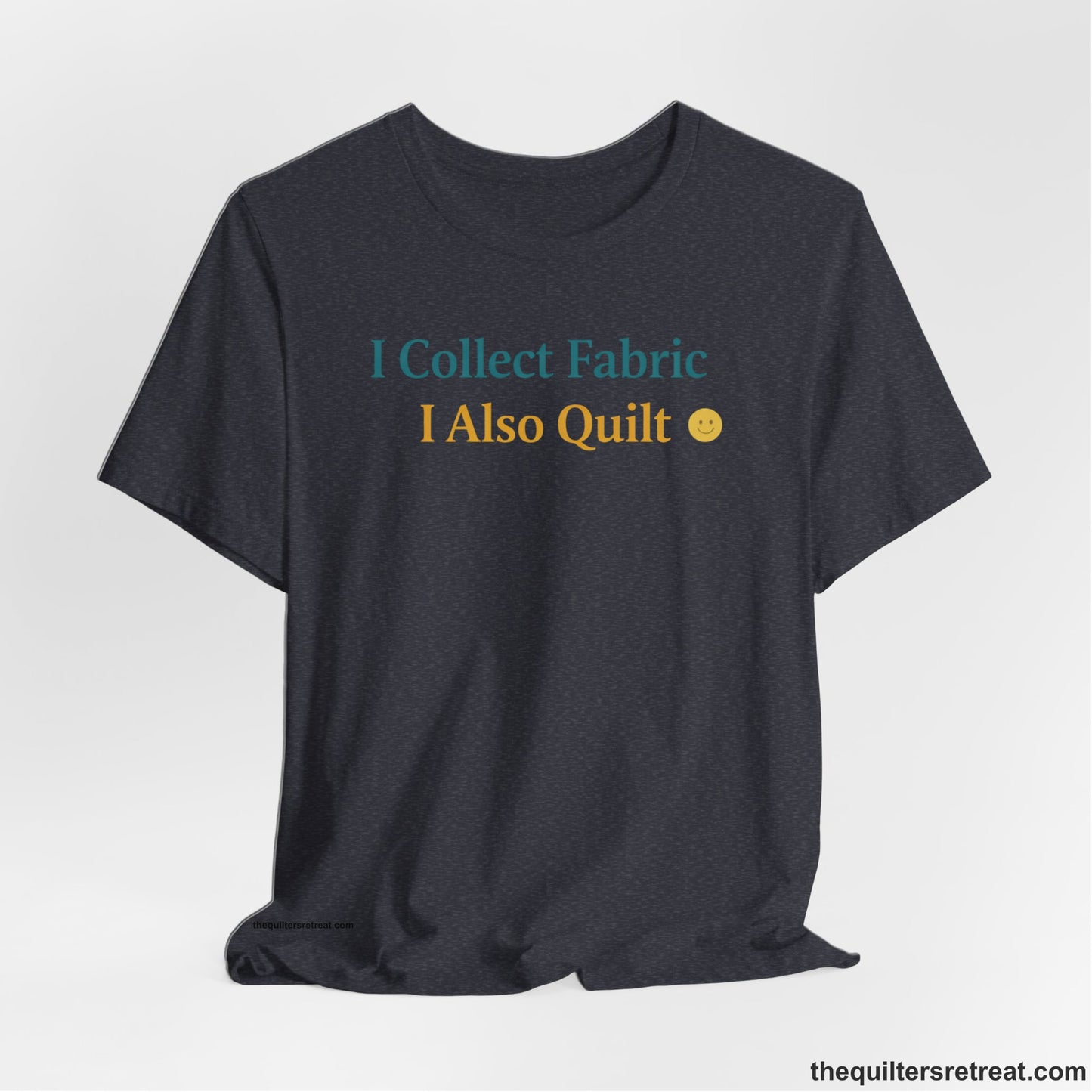 A Heather Navy Short Sleeve T-Shirt with a Colorful text saying "I Collect Fabric I Also Quilt" with a playful, cheerful vibe.
