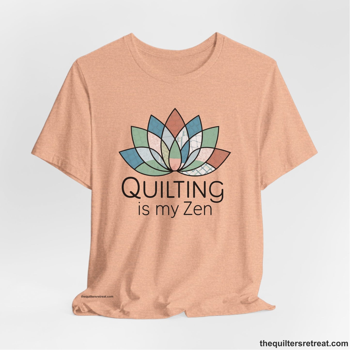 A Heather Peach Short Sleeve T-Shirt with a floral quilt pattern with "Quilting is my Zen" text in a calm, soothing design