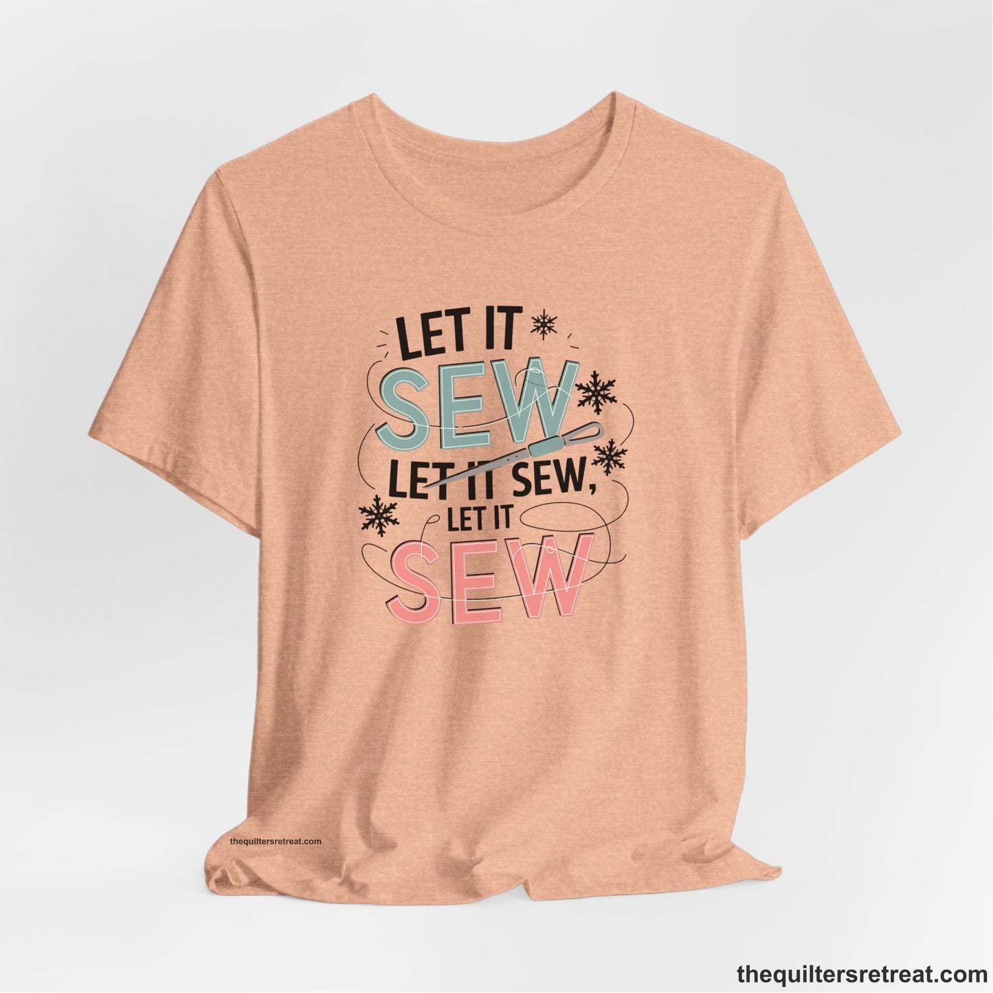 A Heather Peach Short Sleeve T-Shirt with a bold "SEW" text with needle and thread in a modern style