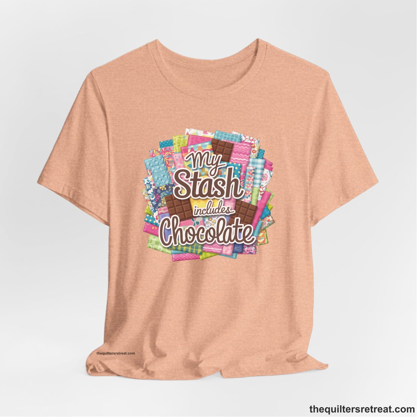 A Heather Peach Short Sleeve T-Shirt with a fabric and chocolate collage with playful "My Stash includes Chocolate" text