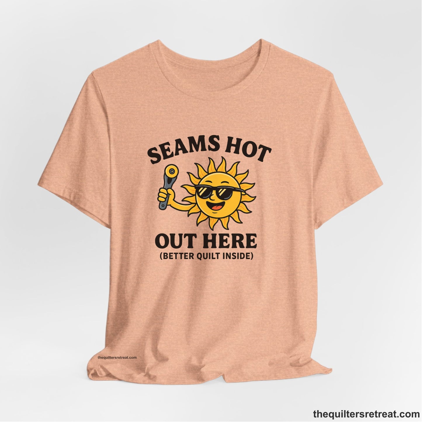 A Heather Peach Short Sleeve T-Shirt with a smiling sun with sunglasses holding a pizza cutter in a playful cartoon style