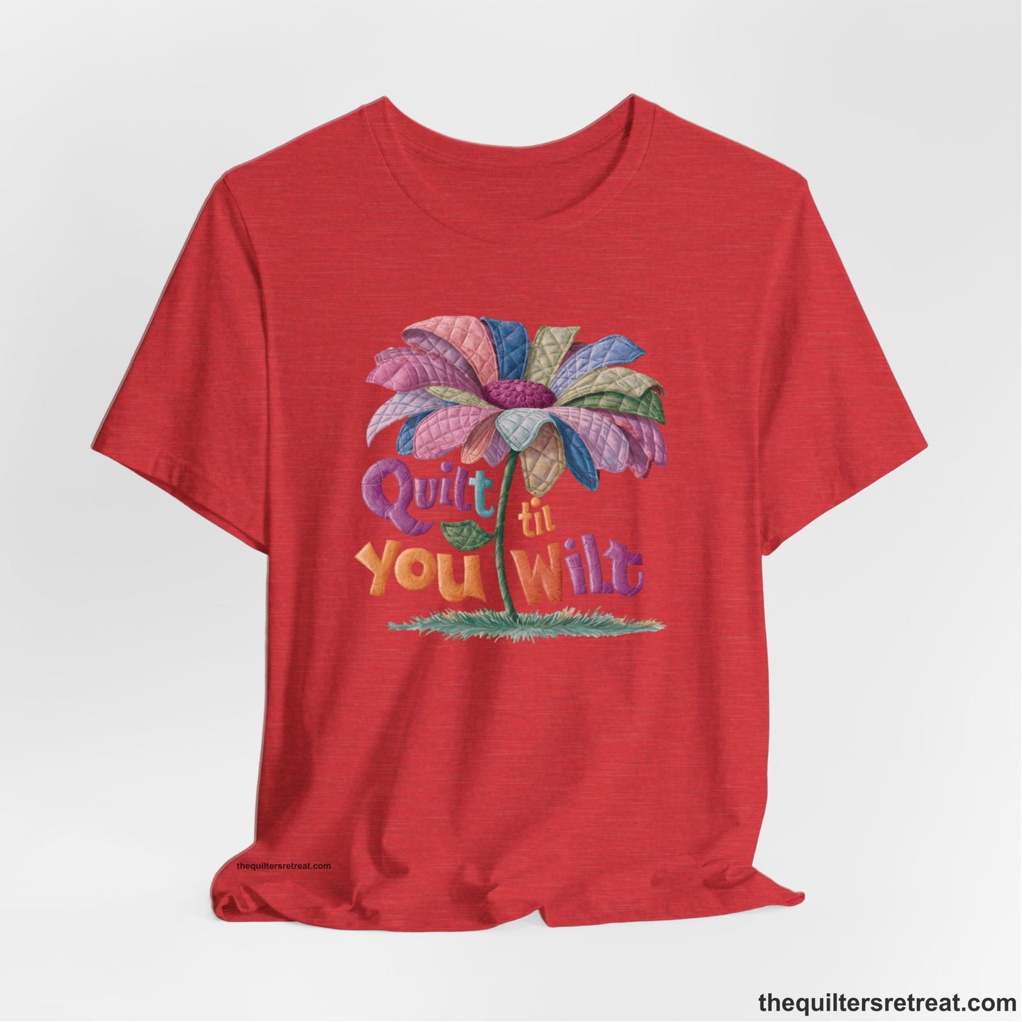 A Heather Red Short Sleeve T-Shirt with a whimsical quilted flower with bold "Quilt til You Wilt" text