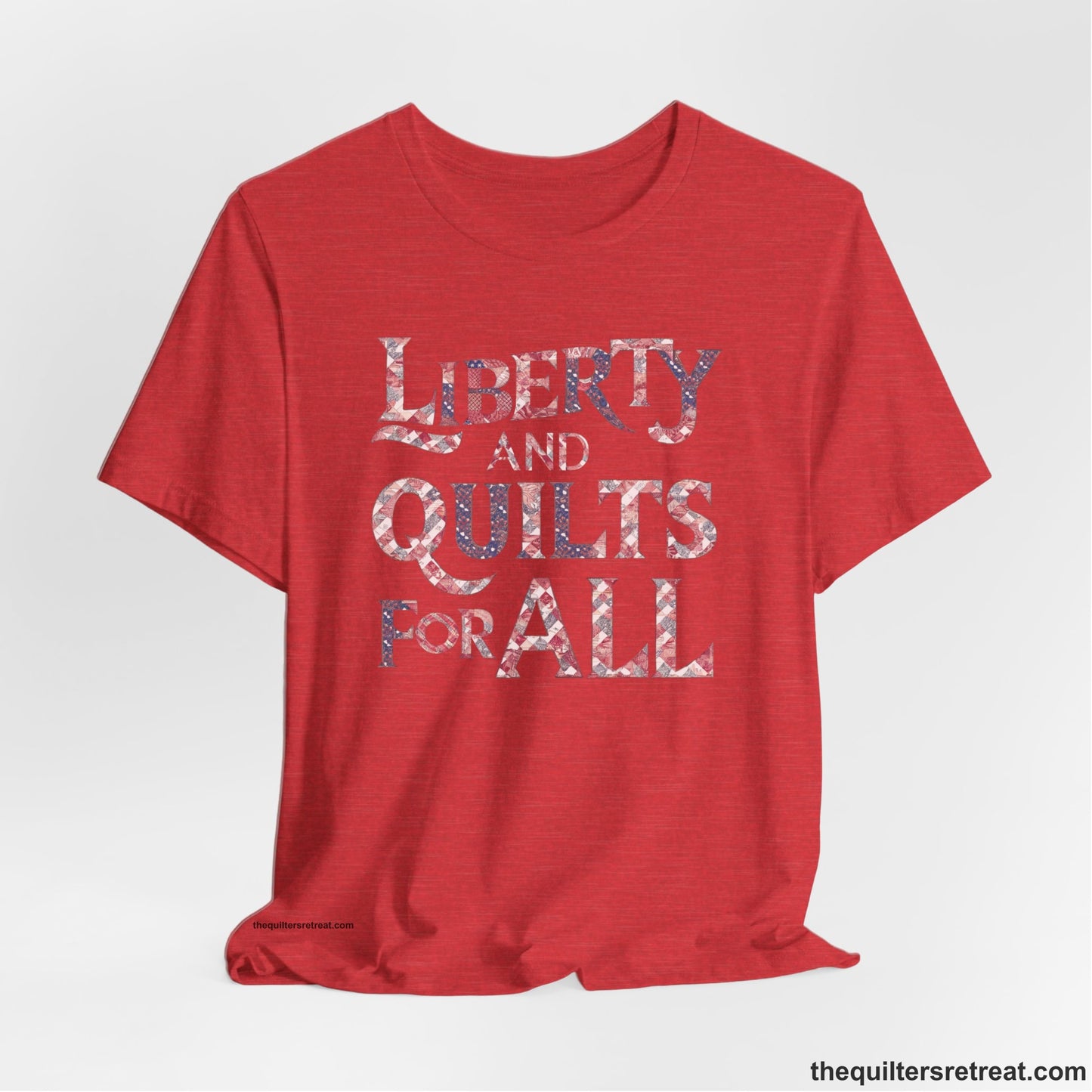 A Heather Red Short Sleeve T-Shirt with a Liberty and Quilts for All" text with patchwork quilt pattern in a vintage style