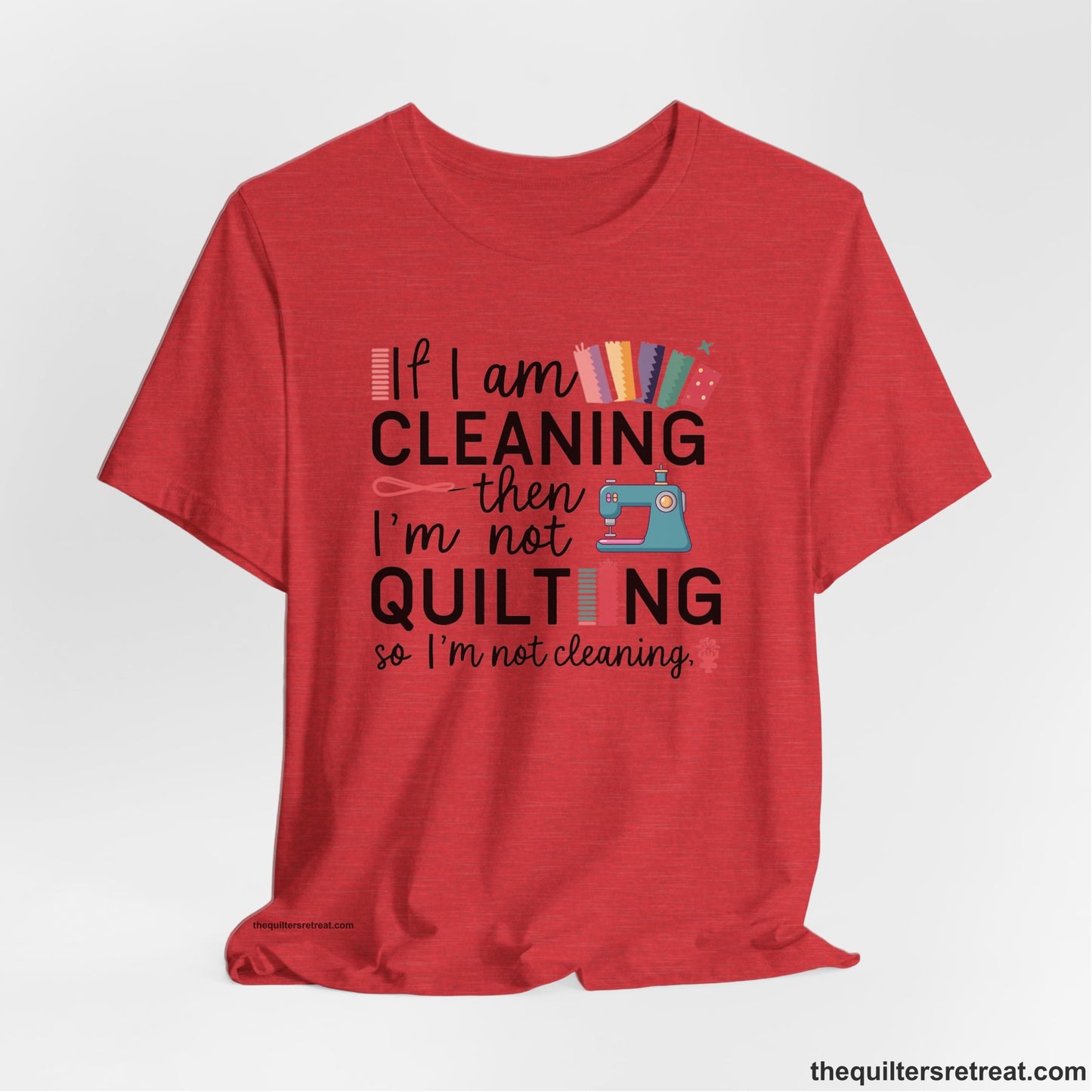 A Heather Red Short Sleeve T-Shirt with a If I am cleaning then I'm not quilting text with sewing machine and fabric graphics