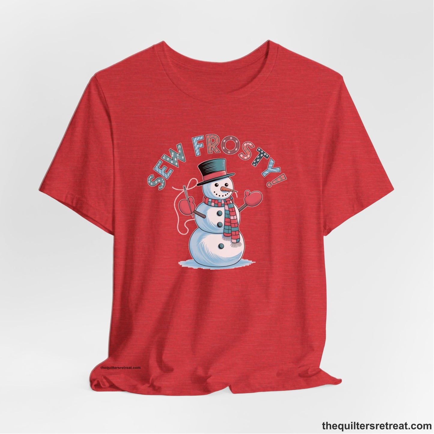 A Heather Red Short Sleeve T-Shirt with a playful snowman sewing illustration with "Sew Frosty!" text in a festive style