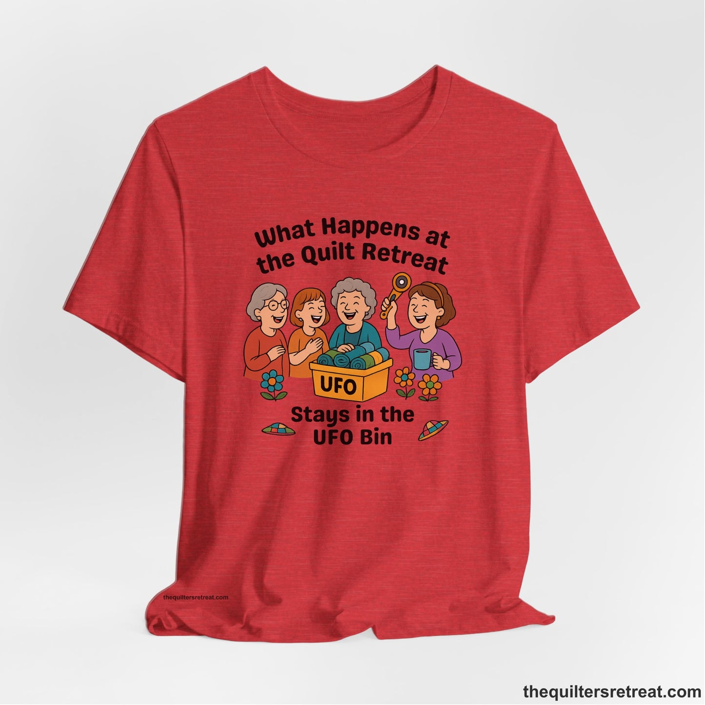 A Heather Red Short Sleeve T-Shirt with a four smiling women with unfinished fabric objects and playful "UFO" text in a cartoon style