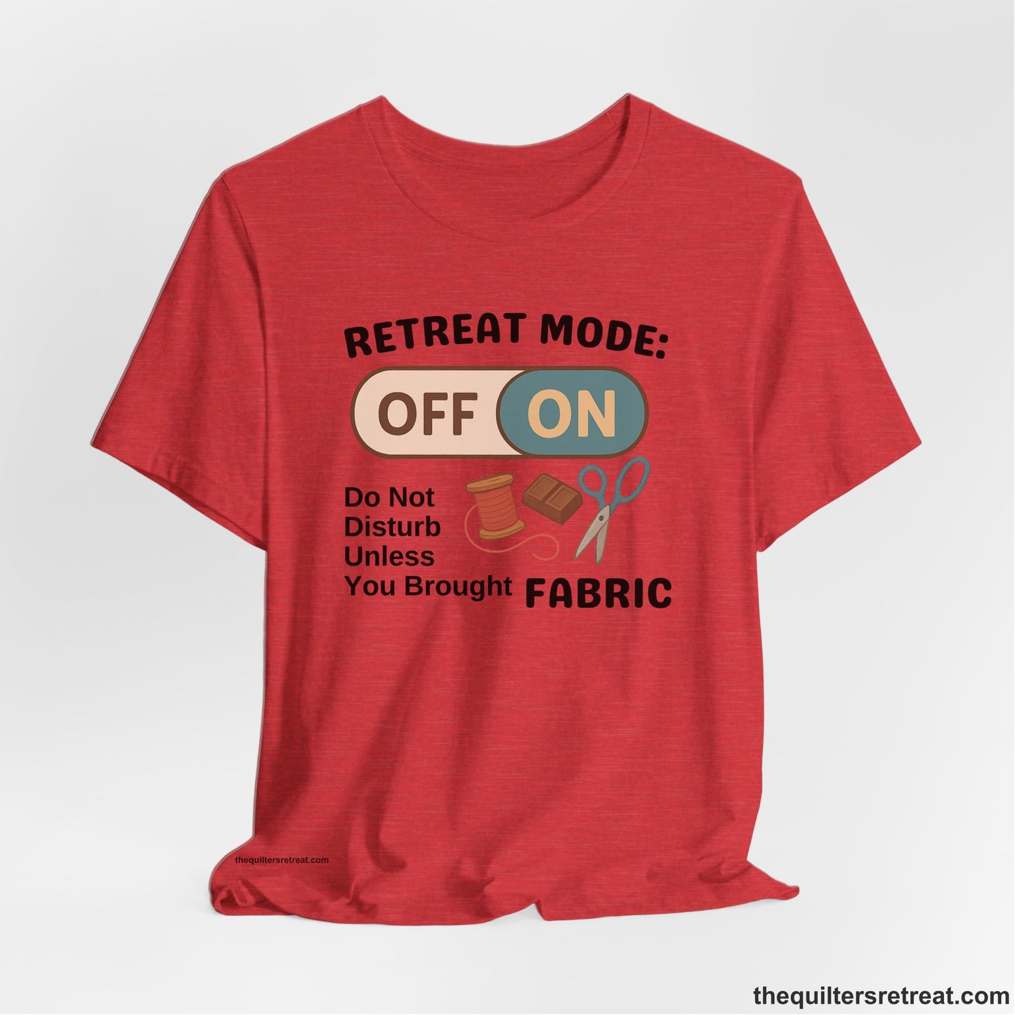 A Heather Red Short Sleeve T-Shirt with a illustration of sewing tools with a playful "OFF ON" switch design