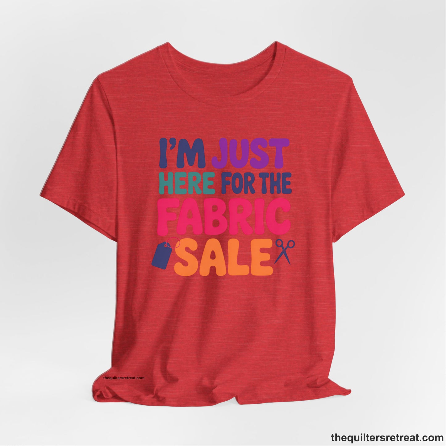 A Heather Red Short Sleeve T-Shirt with a playful "I'm Just Here for the Fabric Sale" text with colorful letters and sewing icons