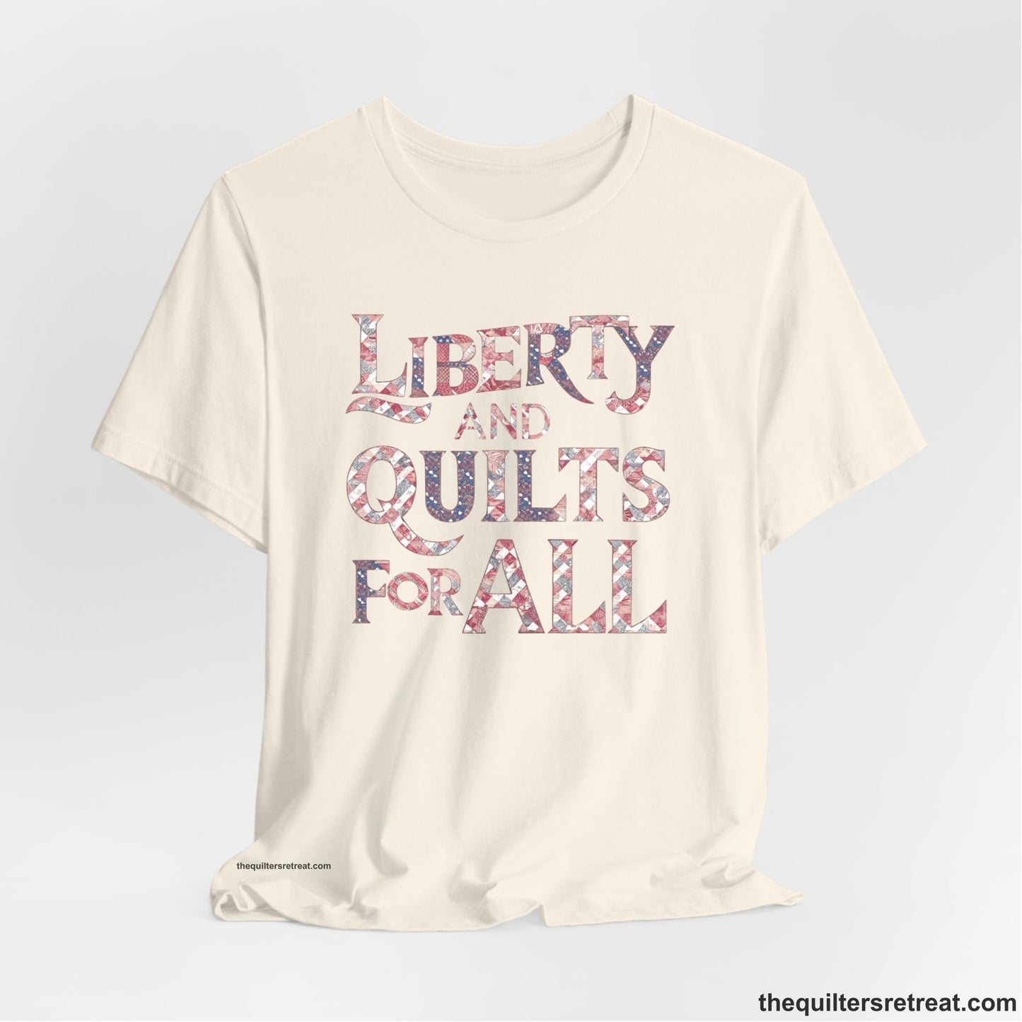 A Natural Short Sleeve T-Shirt with a Liberty and Quilts for All" text with patchwork quilt pattern in a vintage style