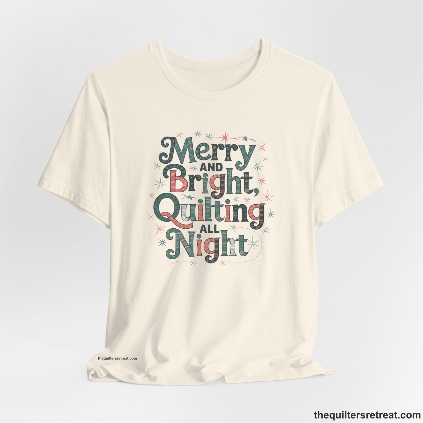 A Natural Short Sleeve T-Shirt with a Merry and Bright Quilting All Night text with festive patterns and stars in a whimsical style