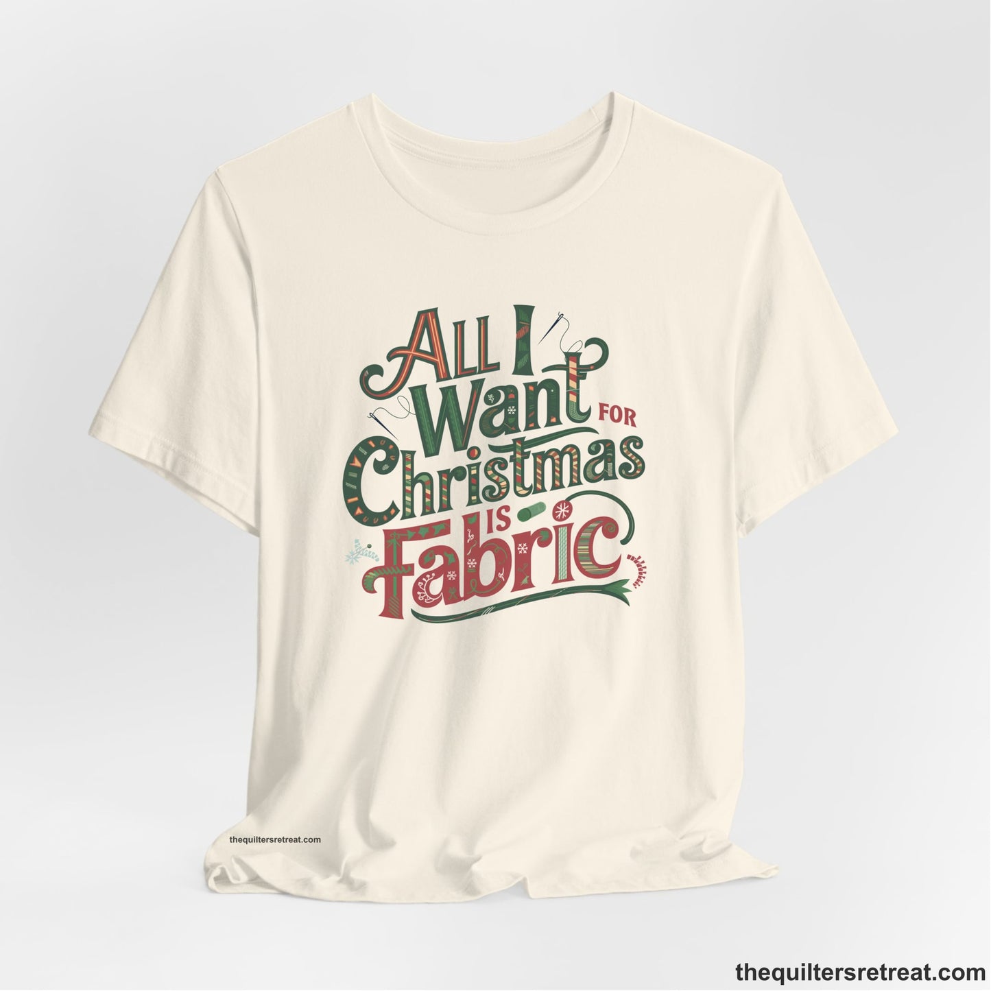 A Natural Short Sleeve T-Shirt with a vintage holiday text "All I Want for Christmas is Fabric" with festive motifs