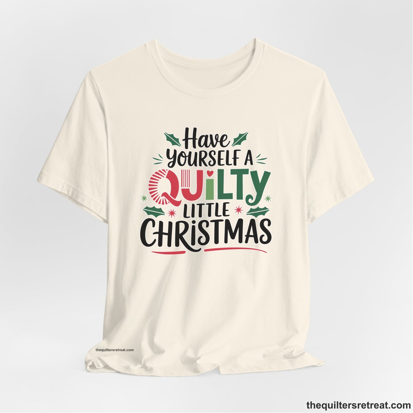A Natural Short Sleeve T-Shirt with a festive "Have Yourself a Quilty Little Christmas" text with holly and quilt patterns