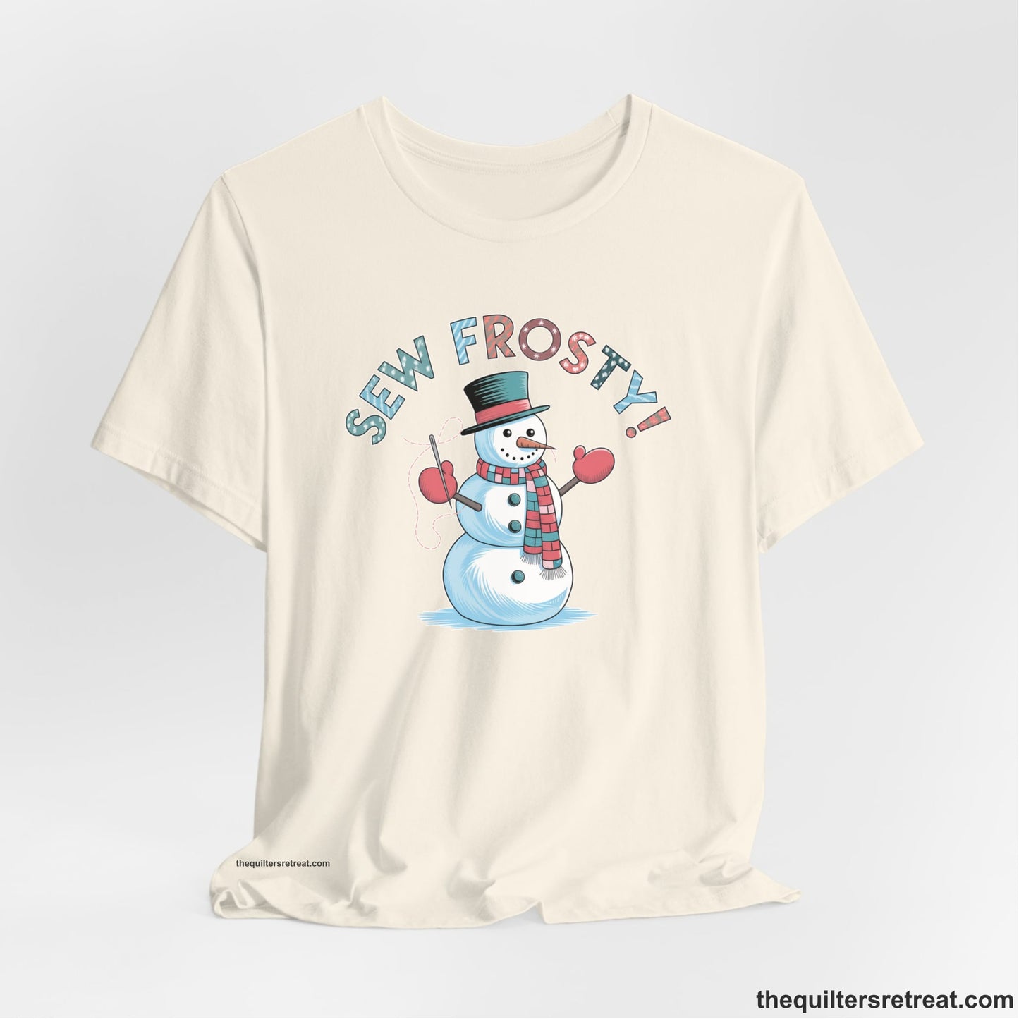 A Natural Short Sleeve T-Shirt with a playful snowman sewing illustration with "Sew Frosty!" text in a festive style