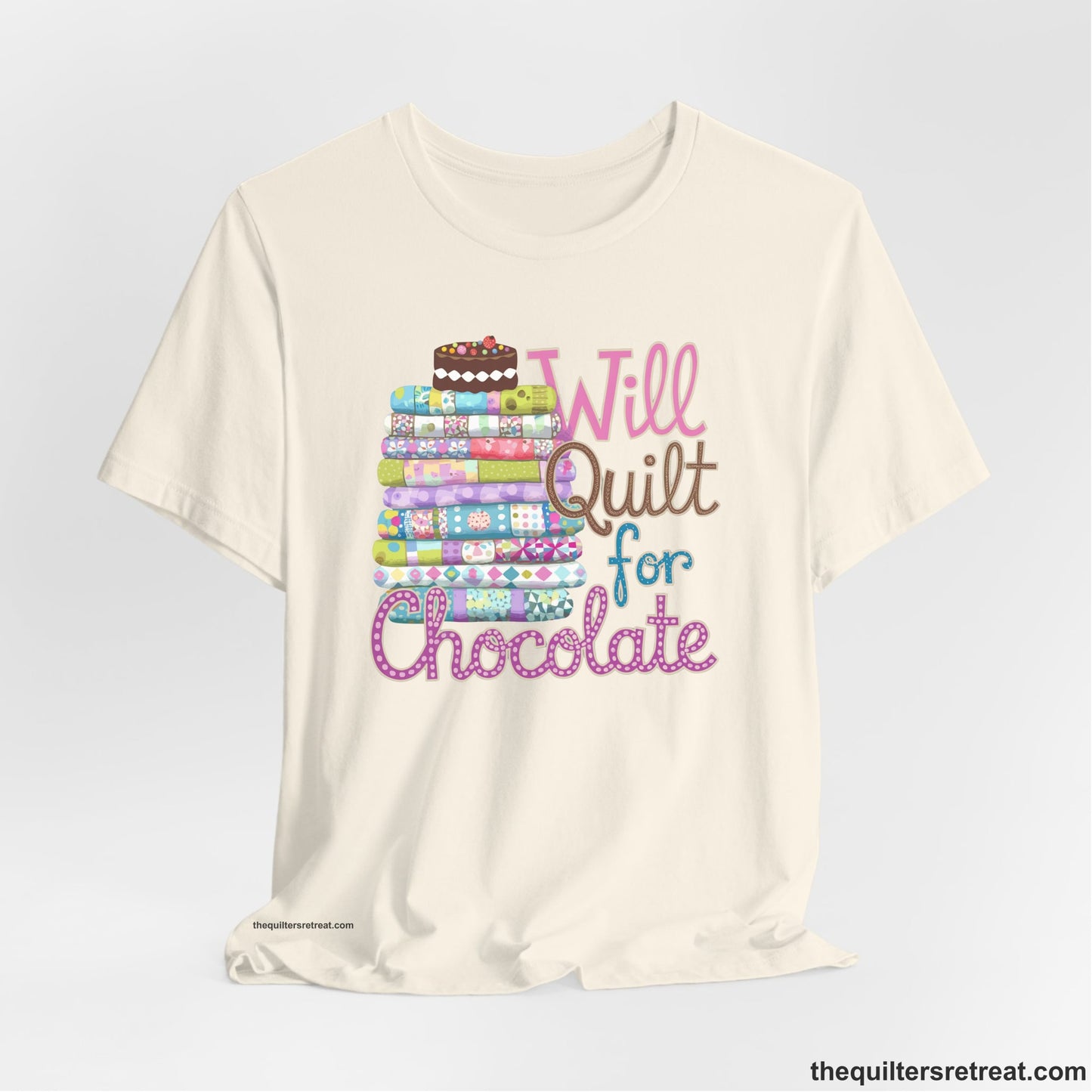 A Natural Short Sleeve T-Shirt with a stack of colorful quilts topped with cake, whimsical "Will Quilt for Chocolate" text