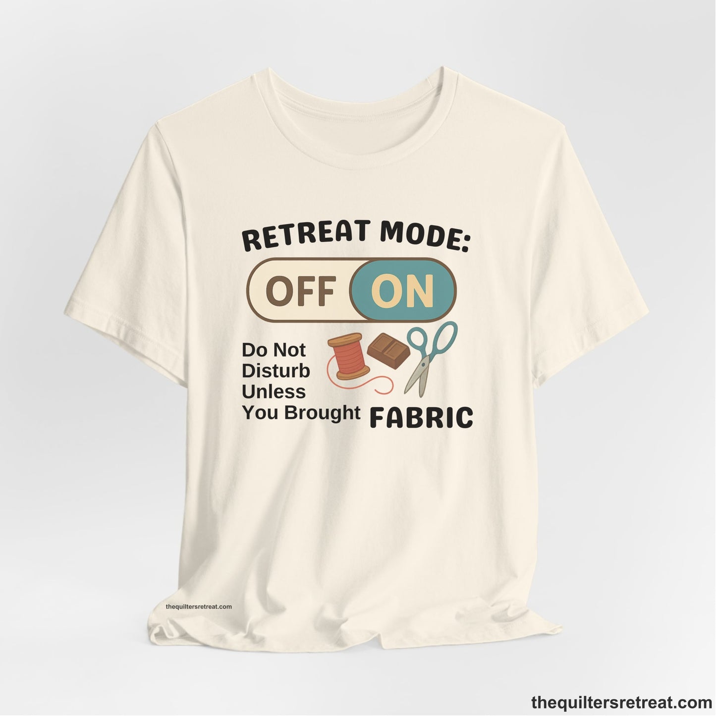 A Natural Short Sleeve T-Shirt with a illustration of sewing tools with a playful "OFF ON" switch design