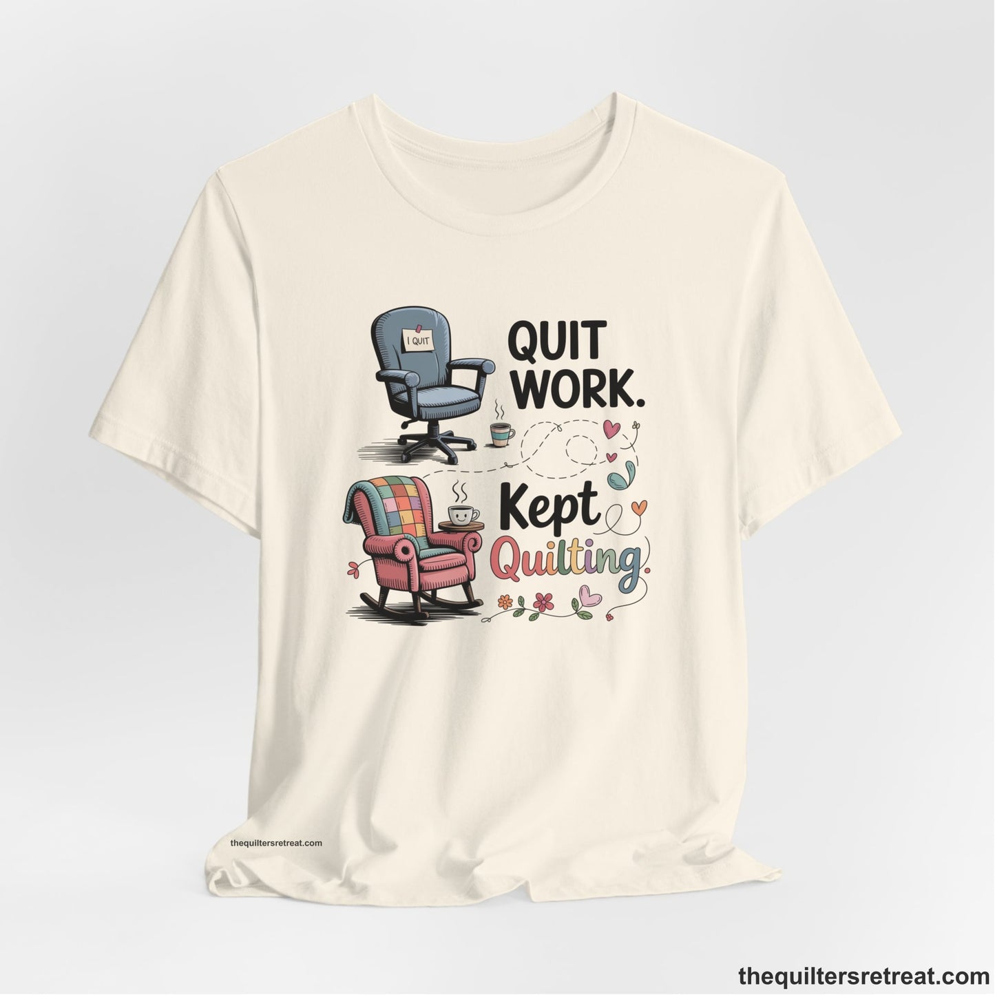 A Natural Short Sleeve T-Shirt with a quit work kept quilting text with cozy chairs and colorful floral accents in a whimsical style