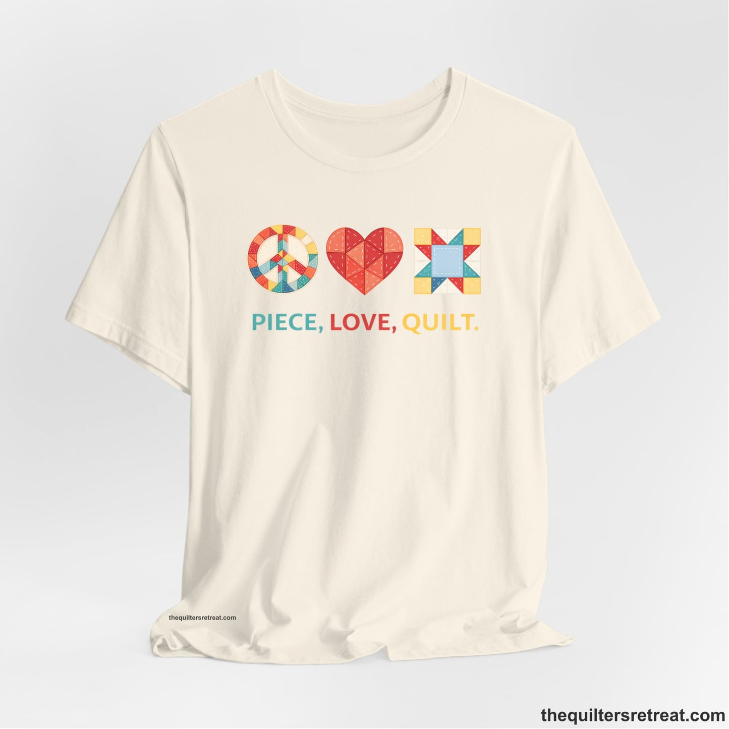 A Natural Short Sleeve T-Shirt with a Colorful quilt patterns, "PIECE, LOVE, QUILT." text, whimsical style.
