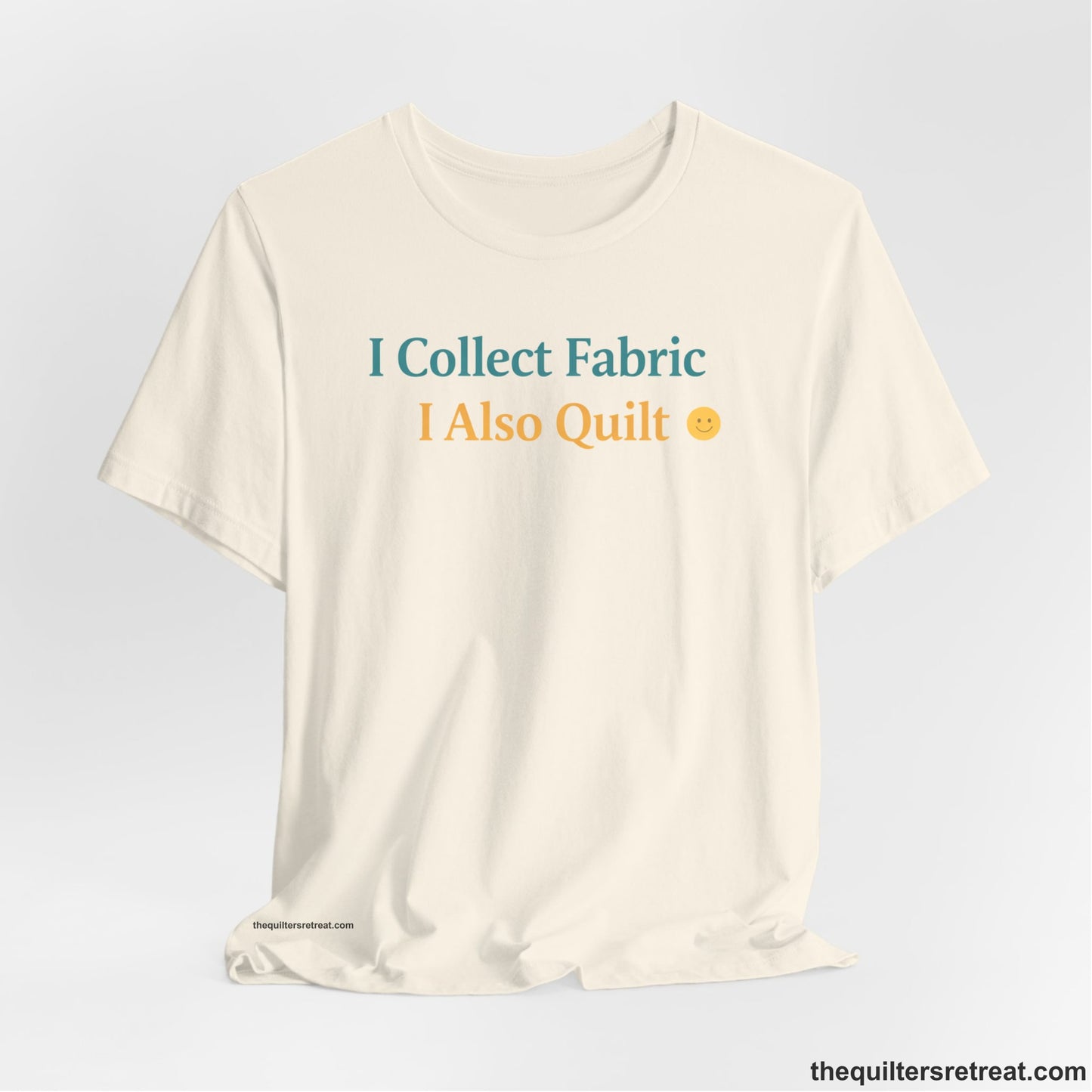 A Natural Short Sleeve T-Shirt with a Colorful text saying "I Collect Fabric I Also Quilt" with a playful, cheerful vibe.