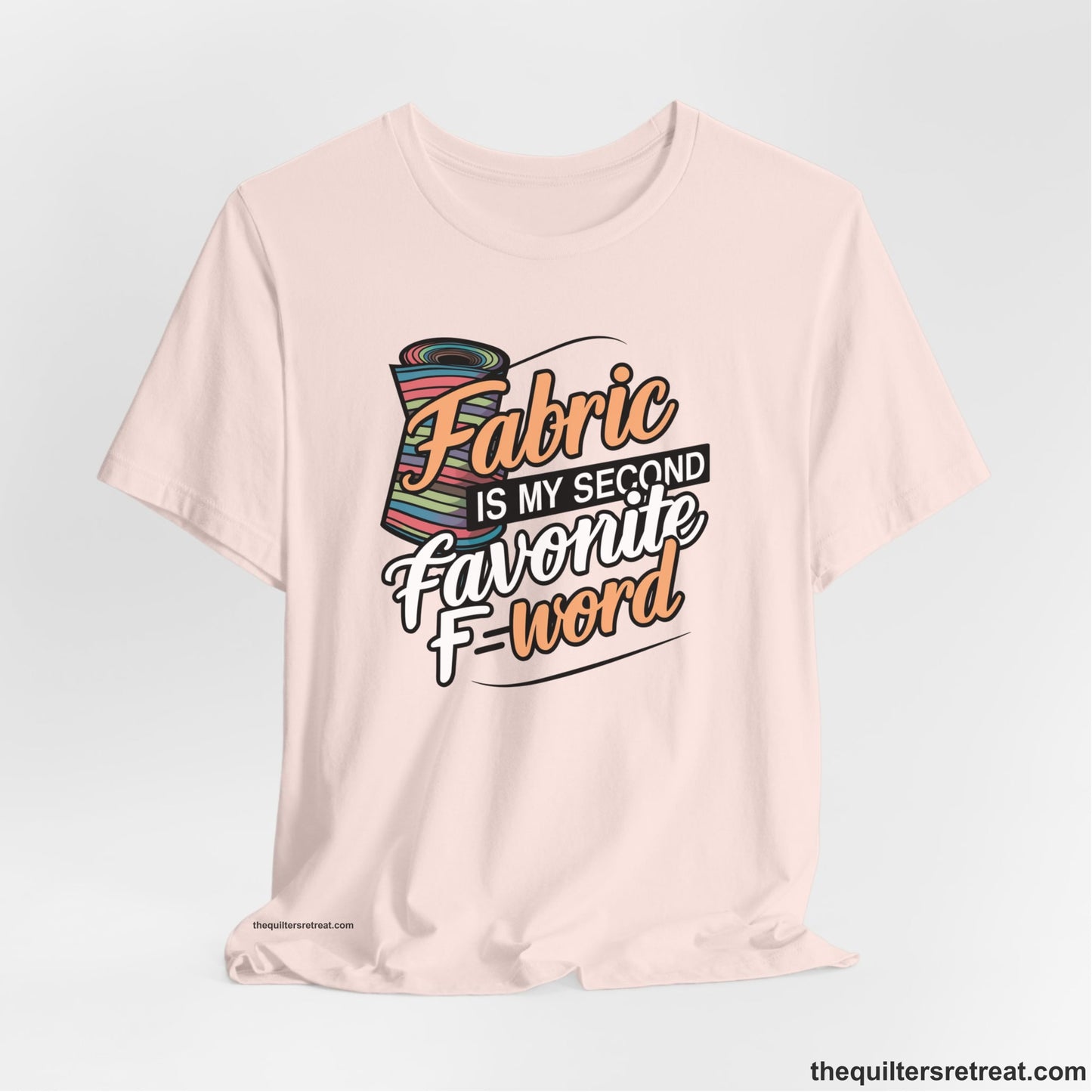A Soft Pink Short Sleeve T-Shirt with a fabric bolt illustration with bold "Fabric Is My Second Favorite F Word" text