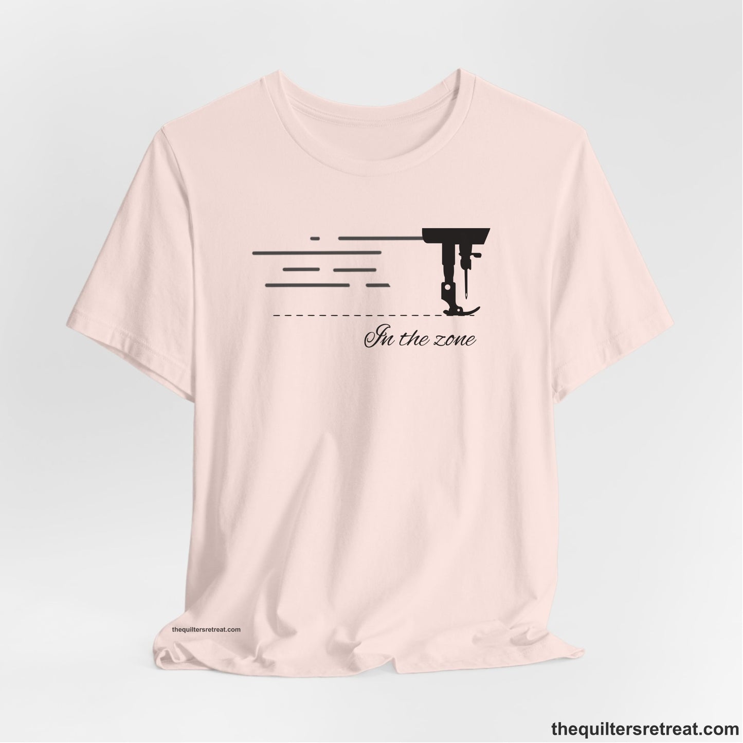A Soft Pink Short Sleeve T-Shirt with a vintage sewing machine illustration with floral accents and "Sewing Mends the Soul" text