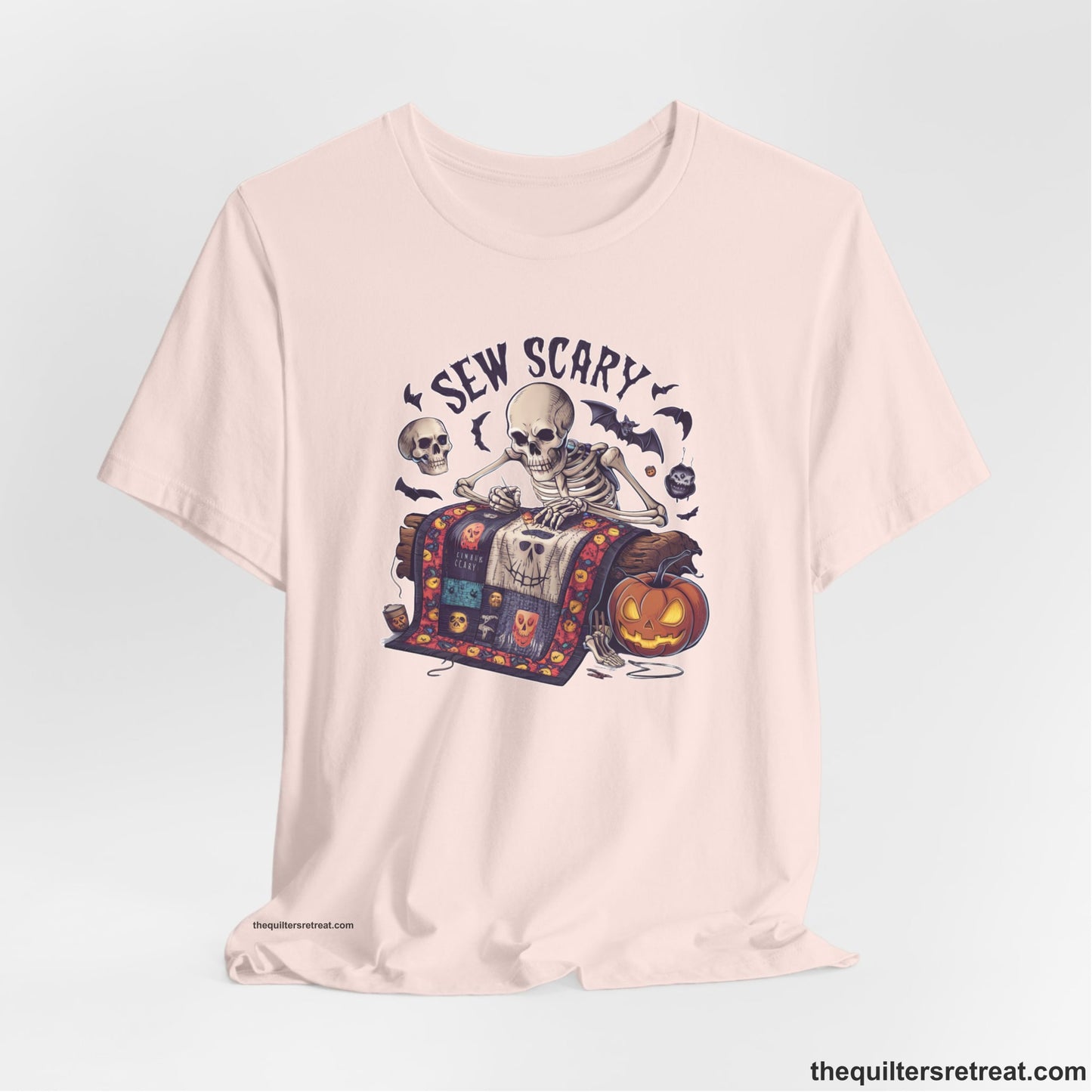 A Soft Pink Short Sleeve T-Shirt with a skeleton quilting with spooky accents and "Sew Scary" text in a Halloween theme
