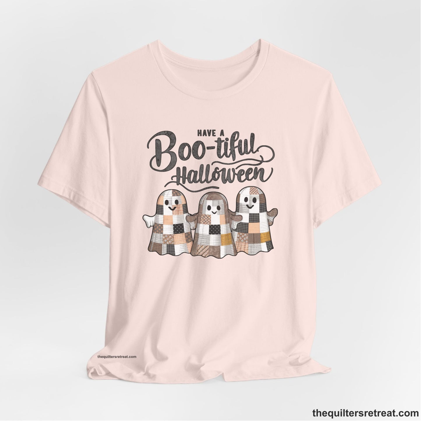 A Soft Pink Short Sleeve T-Shirt with a cute patchwork ghosts with "Boo-tiful Halloween" text in a playful style