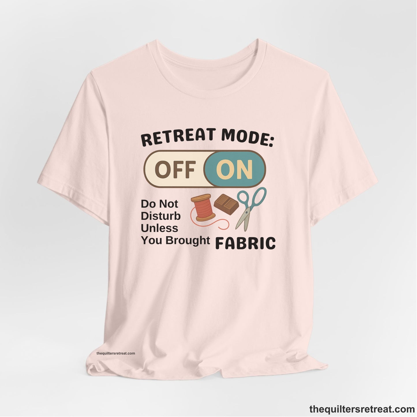 A Soft Pink Short Sleeve T-Shirt with a illustration of sewing tools with a playful "OFF ON" switch design